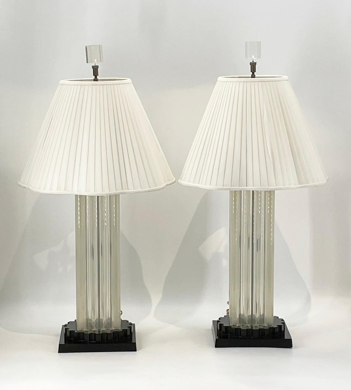 Introducing our exquisite Pair of Clear & Black Lucite Lamps, crafted in the iconic style of renowned designer Charles Hollis Jones. These stunning lamps, reminiscent of the 1960's era, showcase a perfect blend of retro charm and contemporary