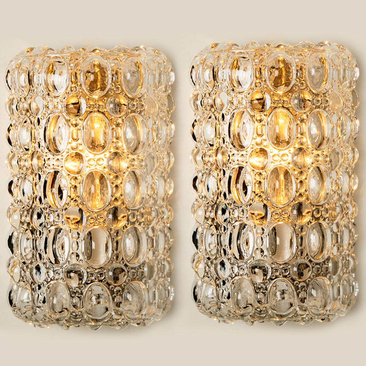 Clear bubble glass wall lights designed in the style of Helena Tynell for Glashütte Limburg around 1960-1970. The rich textured bubbled glass gives a wonderful glow. The back plate of the wall light is dark colored. 

Notice the price is for the