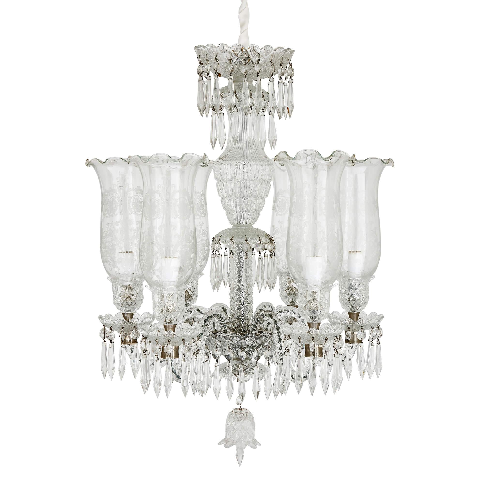 Pair of clear cut and etched glass 6-light chandeliers
Continental, 20th Century 
Height 68cm, diameter 51cm

Expertly crafted from cut and etched glass, the chandelier’s design showcases opulence and luxury, motifs popular during the French Belle