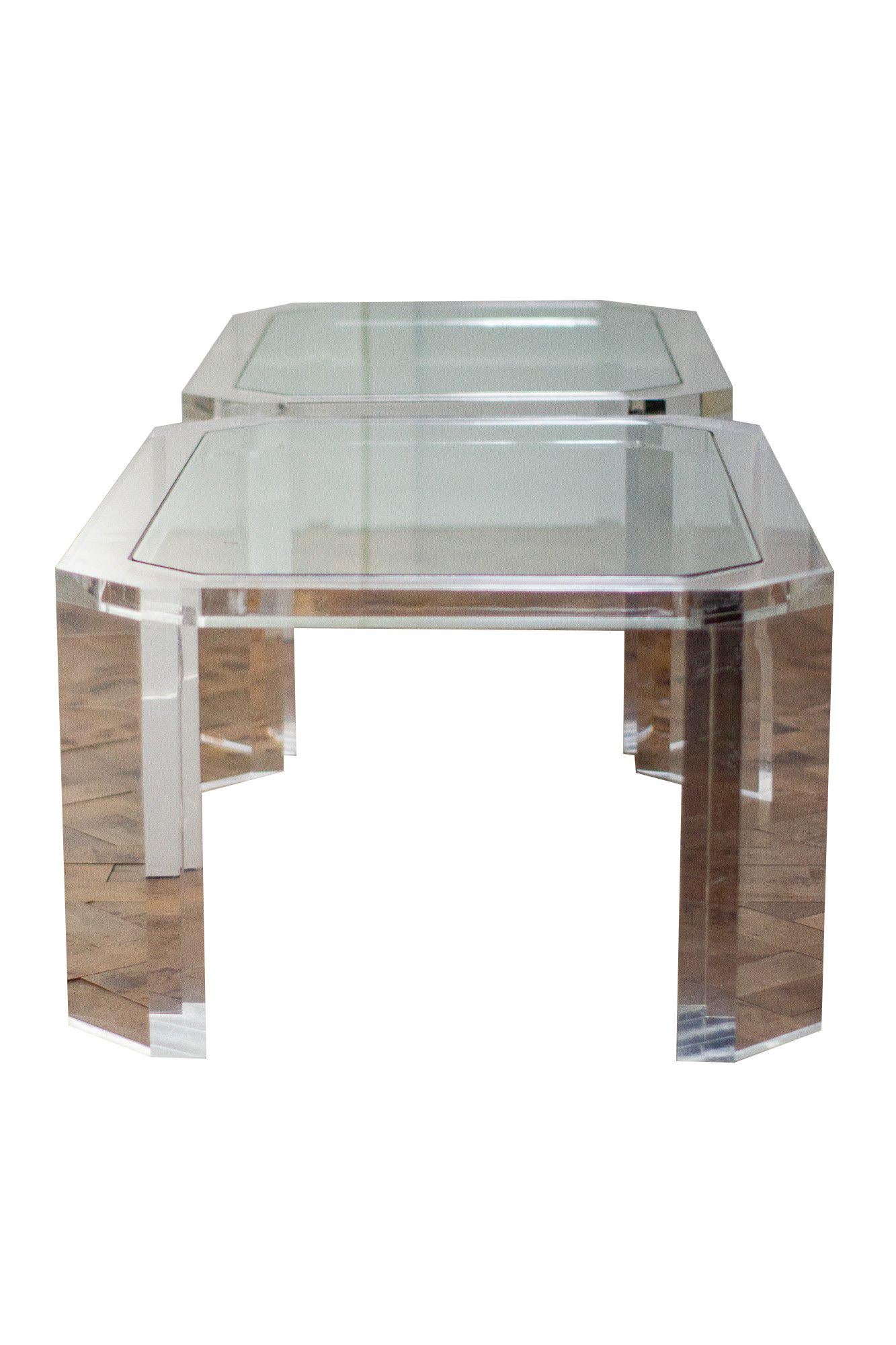 Pair of 1980s coffee tables made of clear Lucite with glass inset top. 

Aged related marks to glass and Lucite. 

Sold as a pair.