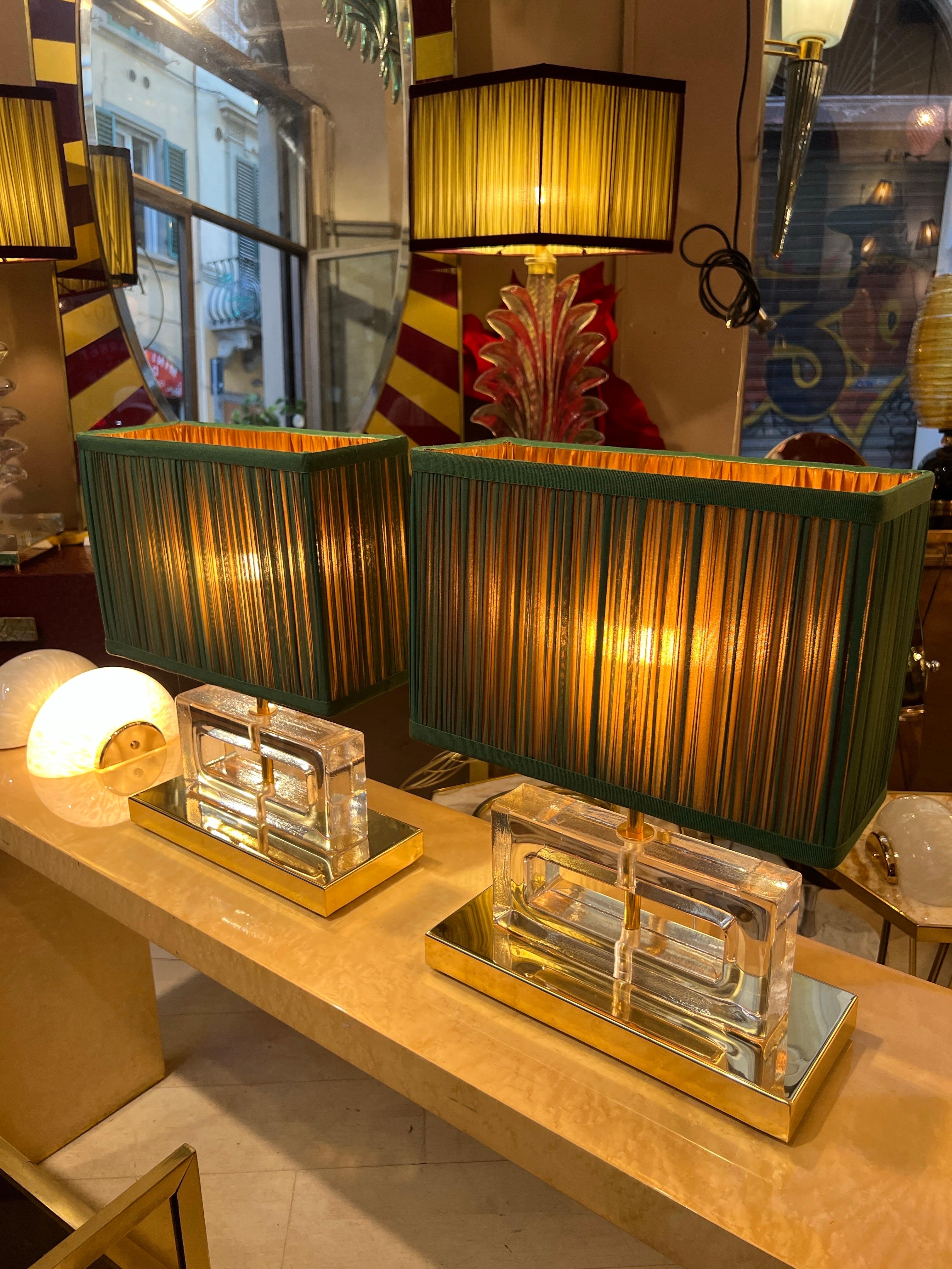 Pair of Clear Murano glass blocks lamps ice effect with brass base and our hand-sewn green and golden orange lampshades.
The geometric clear glass blocks are solid, thick and heavy.
The double color lampshades are handmade in our internal laboratory