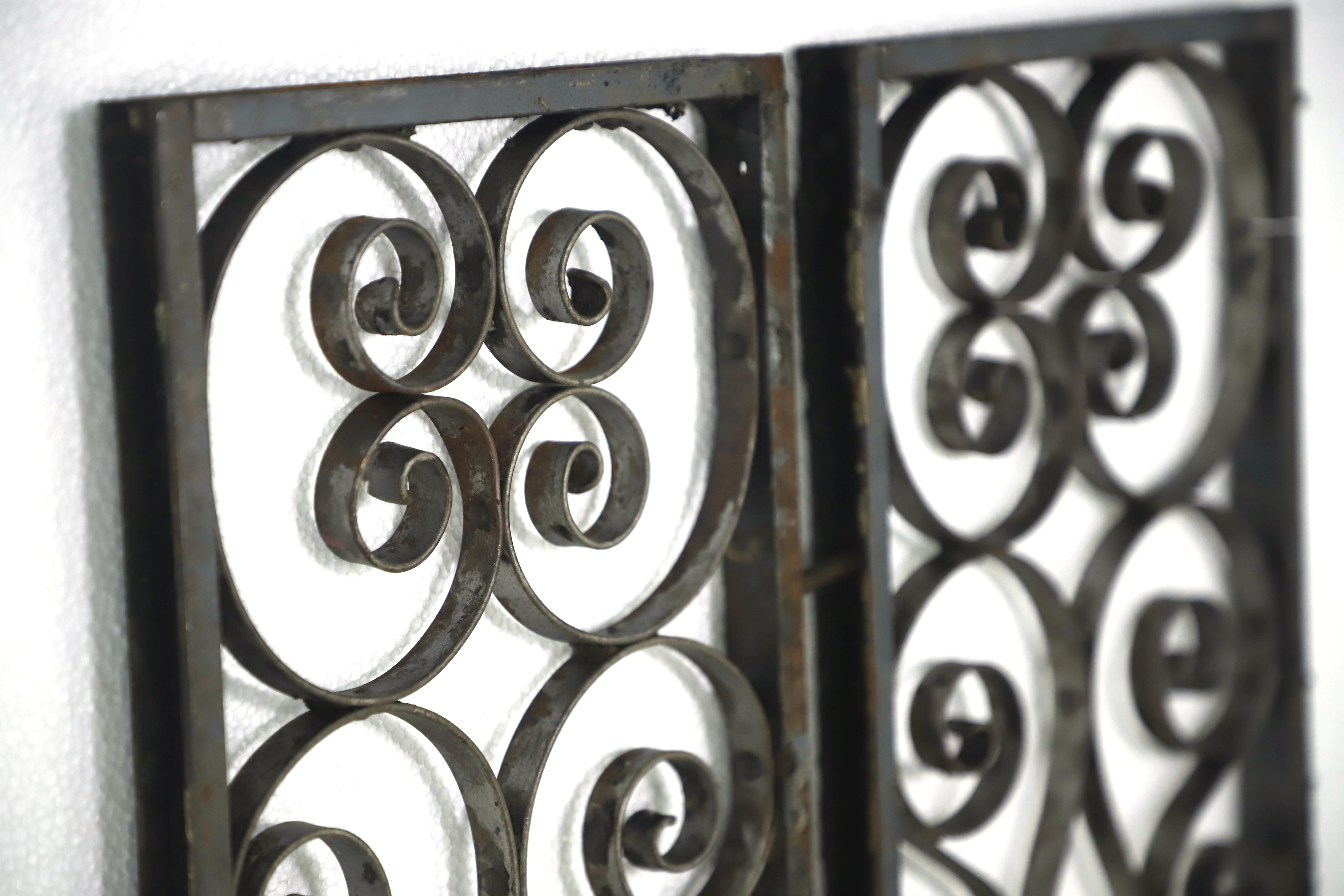 Black wrought iron curled and swirled panels in a steel frame. Clenched + pinned construction shows their age. Priced as a pair. Please note, this item is located in one of our NYC locations.