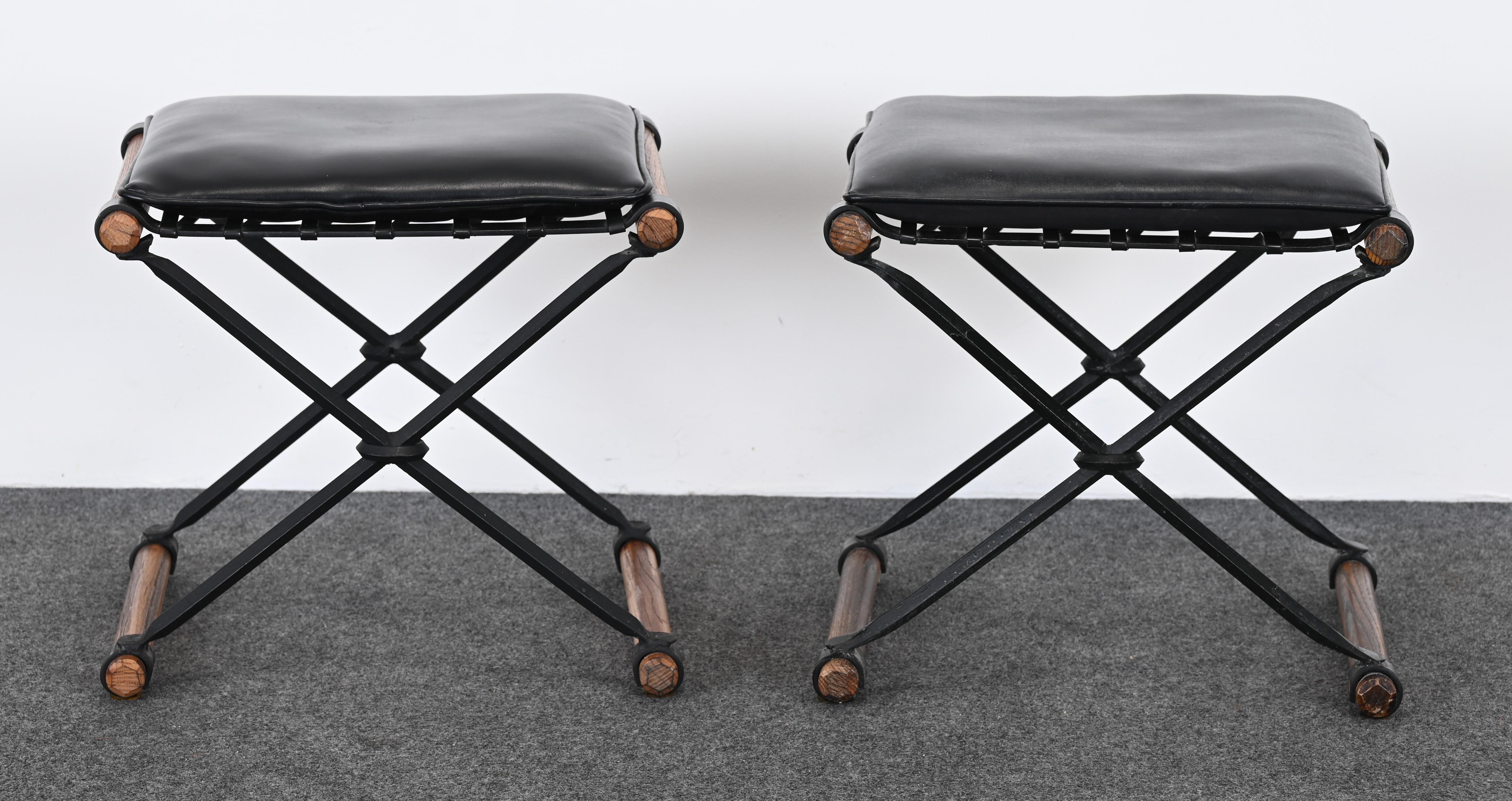 A Classical Pair of Cleo Baldon X-benches or stools for Terra Furniture Company. These iconic Mid-Century Benches would look great in any modern interior. These came out of an estate and have the original vinyl fabric in black. Beautiful oak accents