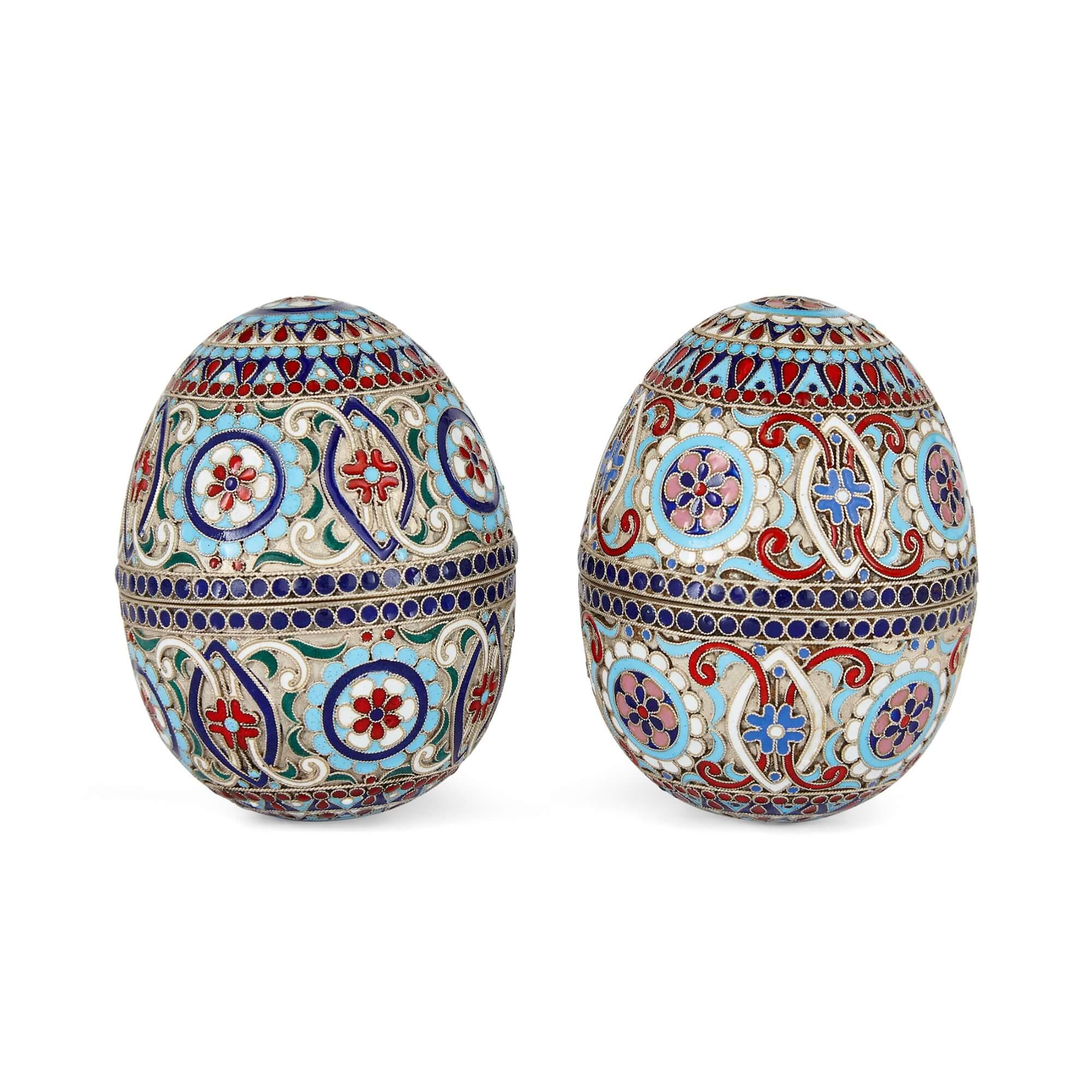 Pair of cloisonné enamel decorated and silver gilt eggs 
Russian, 20th Century 
Height 7cm, diameter 5cm

This duo of Russian antique eggs, artfully hand-fashioned from gilded silver and bedecked with painstakingly rendered cloisonné enamel, serve