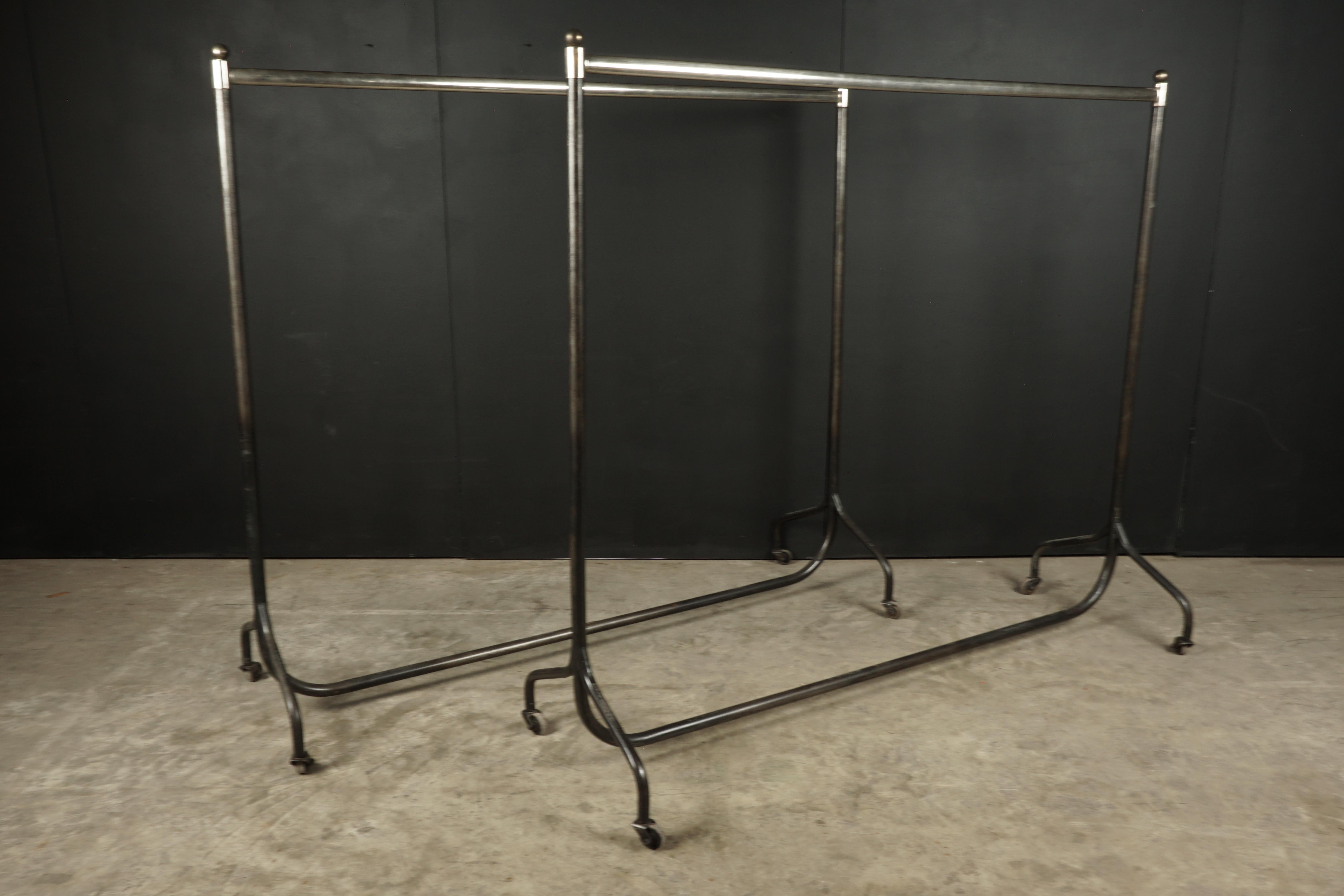Pair of clothing racks from France, manufactured by Siegel, Paris. Chrome and steel construction with functional castors.