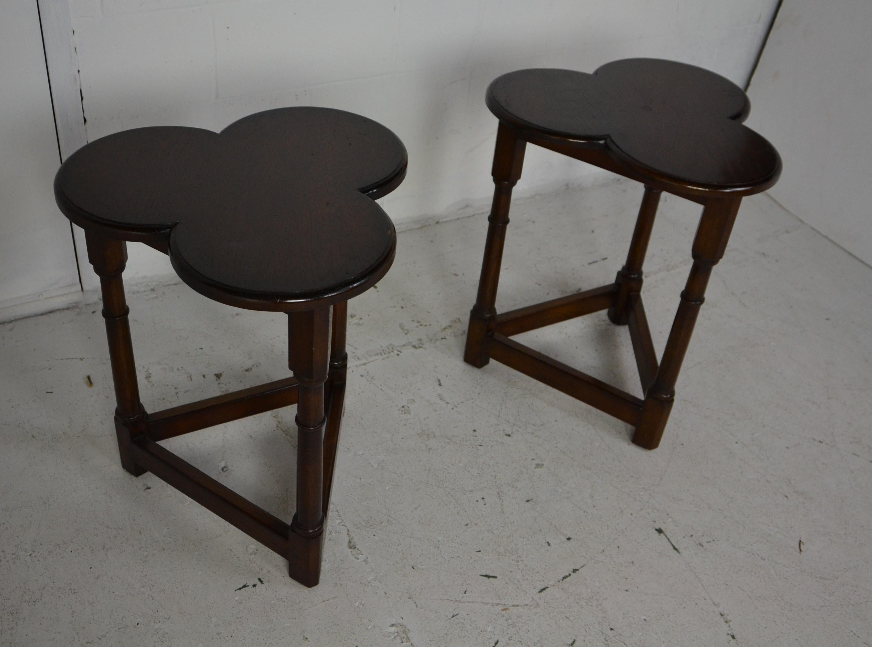 A pair of Clover-leaf style Side Tables in solid oak. Turned legs, 3 leaf clover shaped tops. Designed and manufactured in the English 17th. century style by an American company. 
 ( 