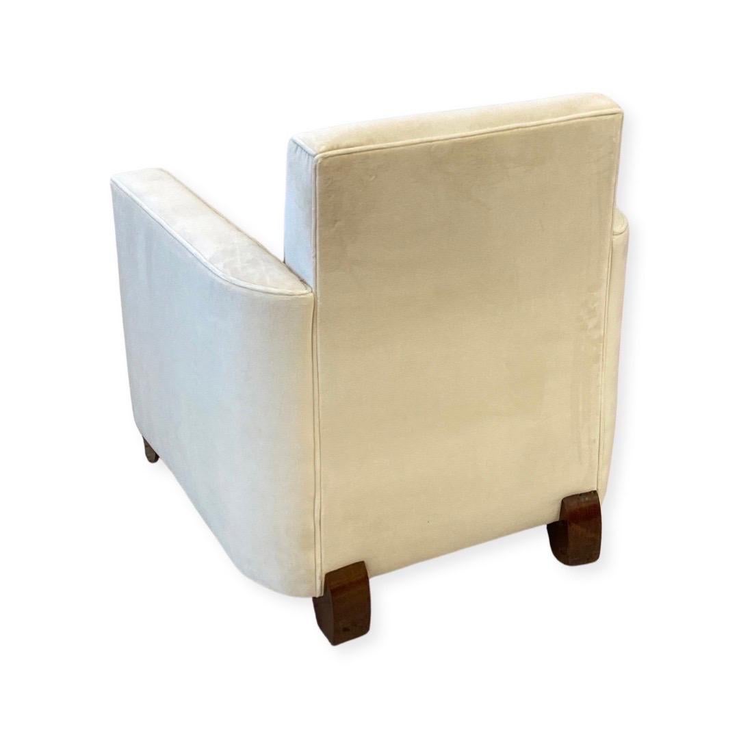 Pair of Club Chairs made out of a frame of solid Rosewood and upholstered in a Pearl White color silk velvet.  These chairs were designed in France in the style of Jules Leleu.

Jules Leleu was a prominent French Art Deco designer known for his