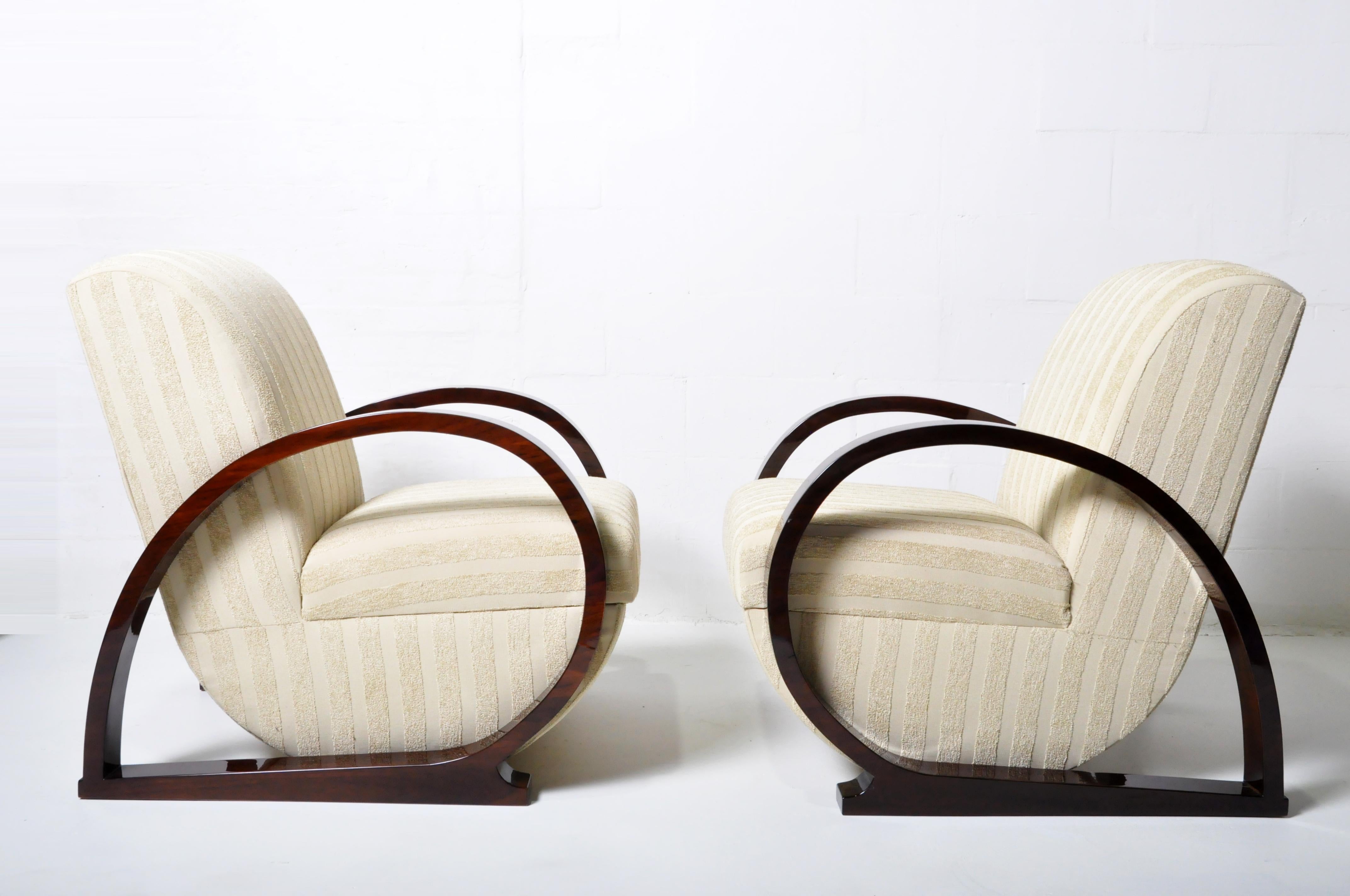 These Hungarian lounge chairs are newly made. Hungarian Art Deco is very similar to French Art Deco but often simpler. The arms are walnut veneer and finished in lacquer. The upholstery on these club chairs is chenille.