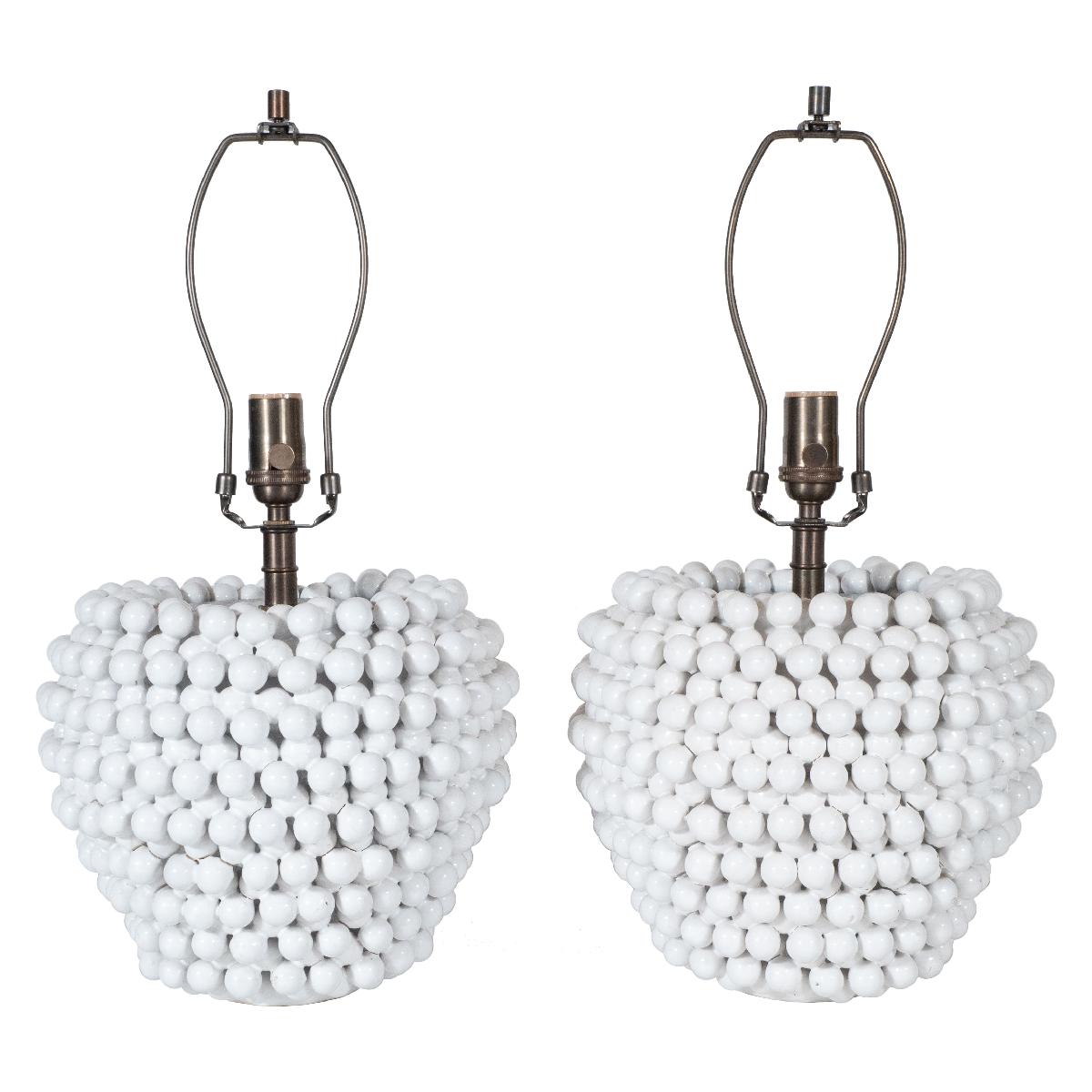 Pair of white glazed ceramic table lamps composed of clustered white balls with patinated brass hardware.