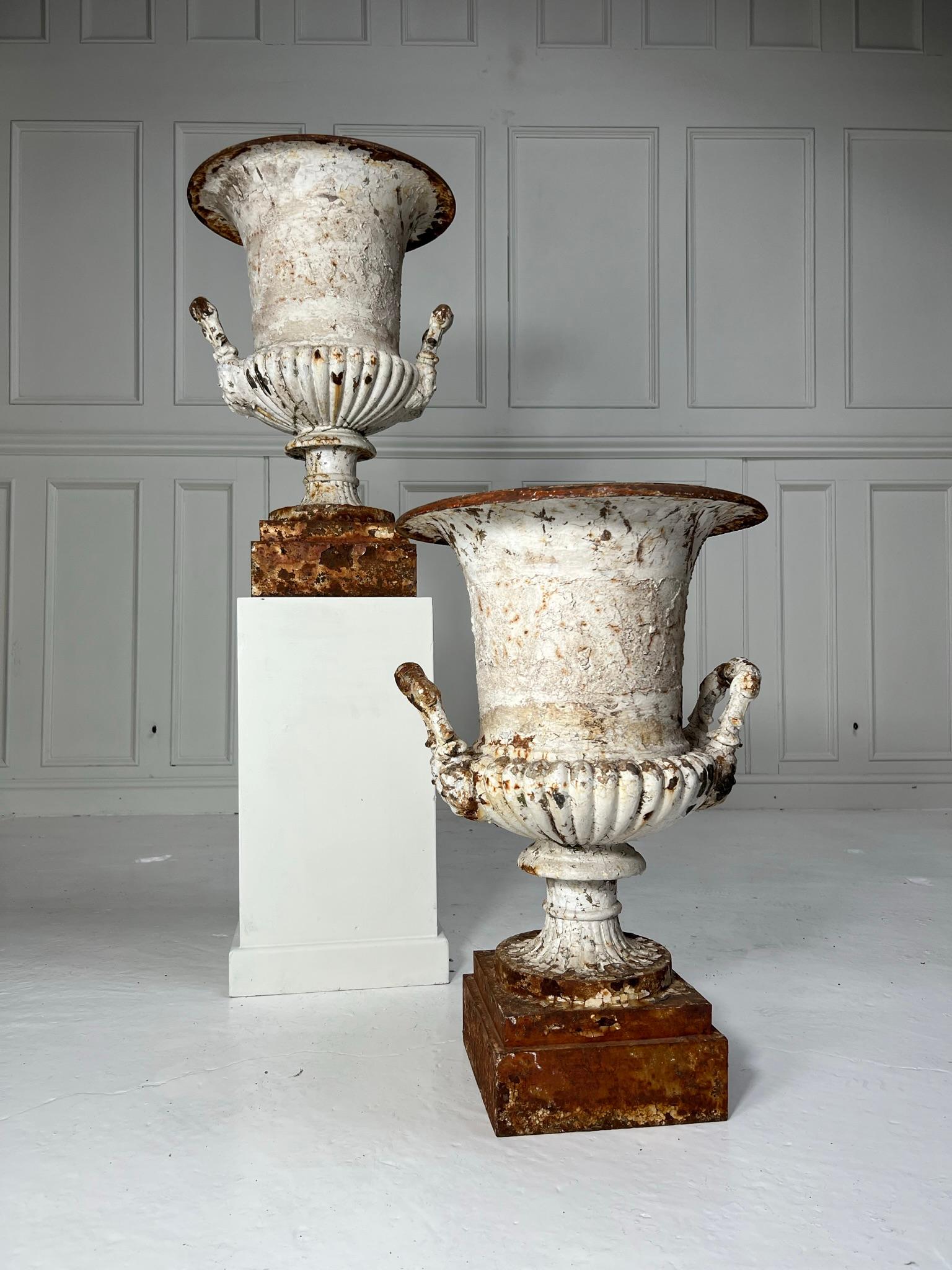 Pair of Coalbrookdale garden urn planters C1880.

This model was catalogued as the ‘Bell’ garden varse.

Square stepped base leading up to a gadrooned bowl with masked handles either side.

The quality of casting is superb and is visible on the