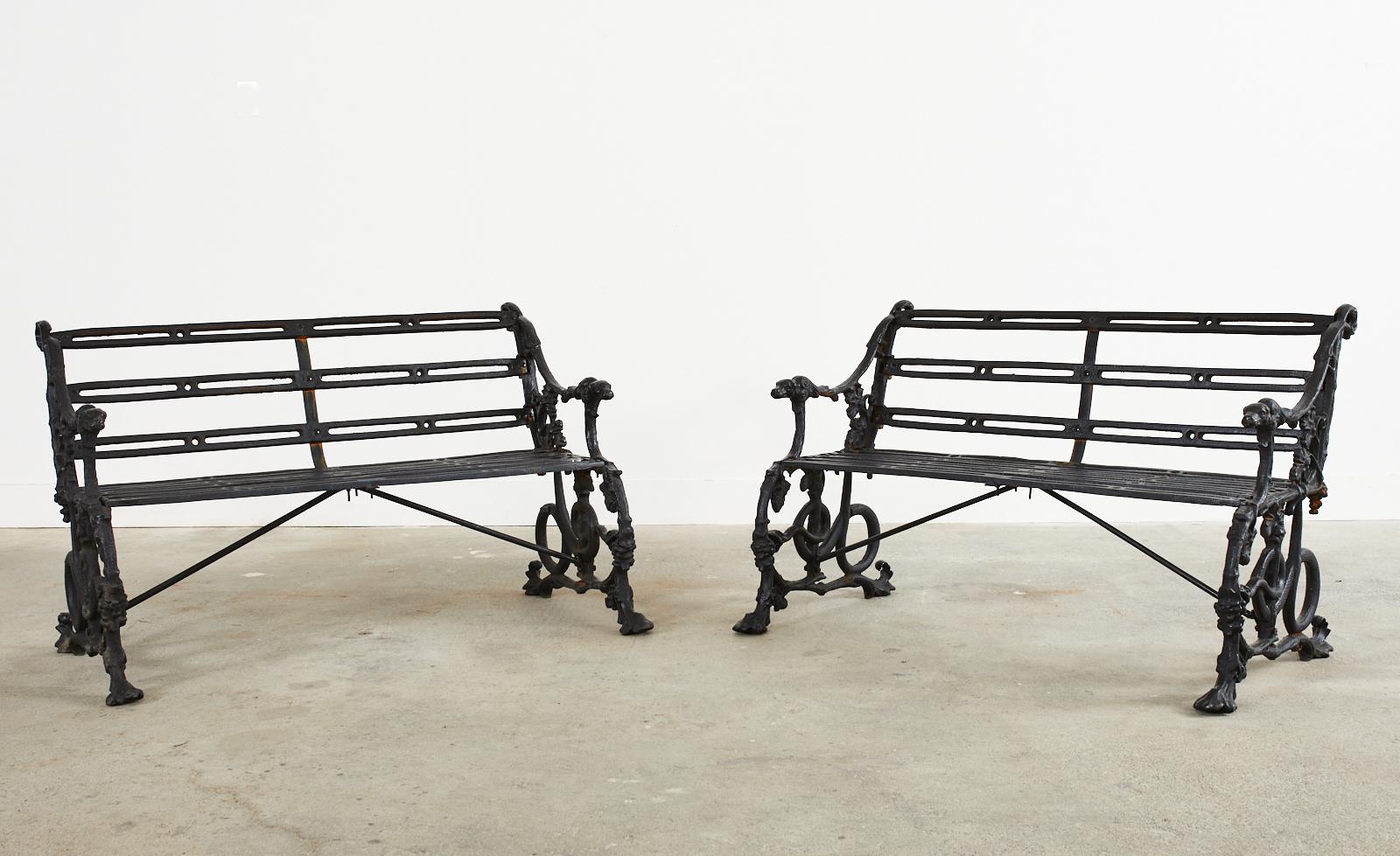 Spectacular pair of English cast iron garden benches having a 