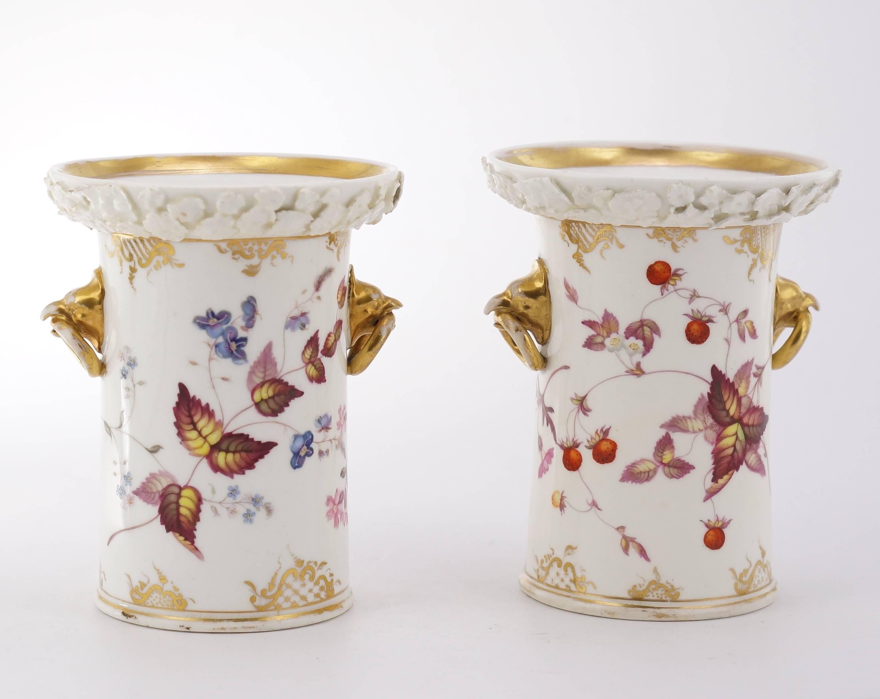 Pair of remarkable coalport spill vases, the straight sided forms painted with wild strawberries and dog roses, the handles modelled as birds heads with rings in their beaks, the rims with encrusted daisy heads left in the white.
Unmarked, circa