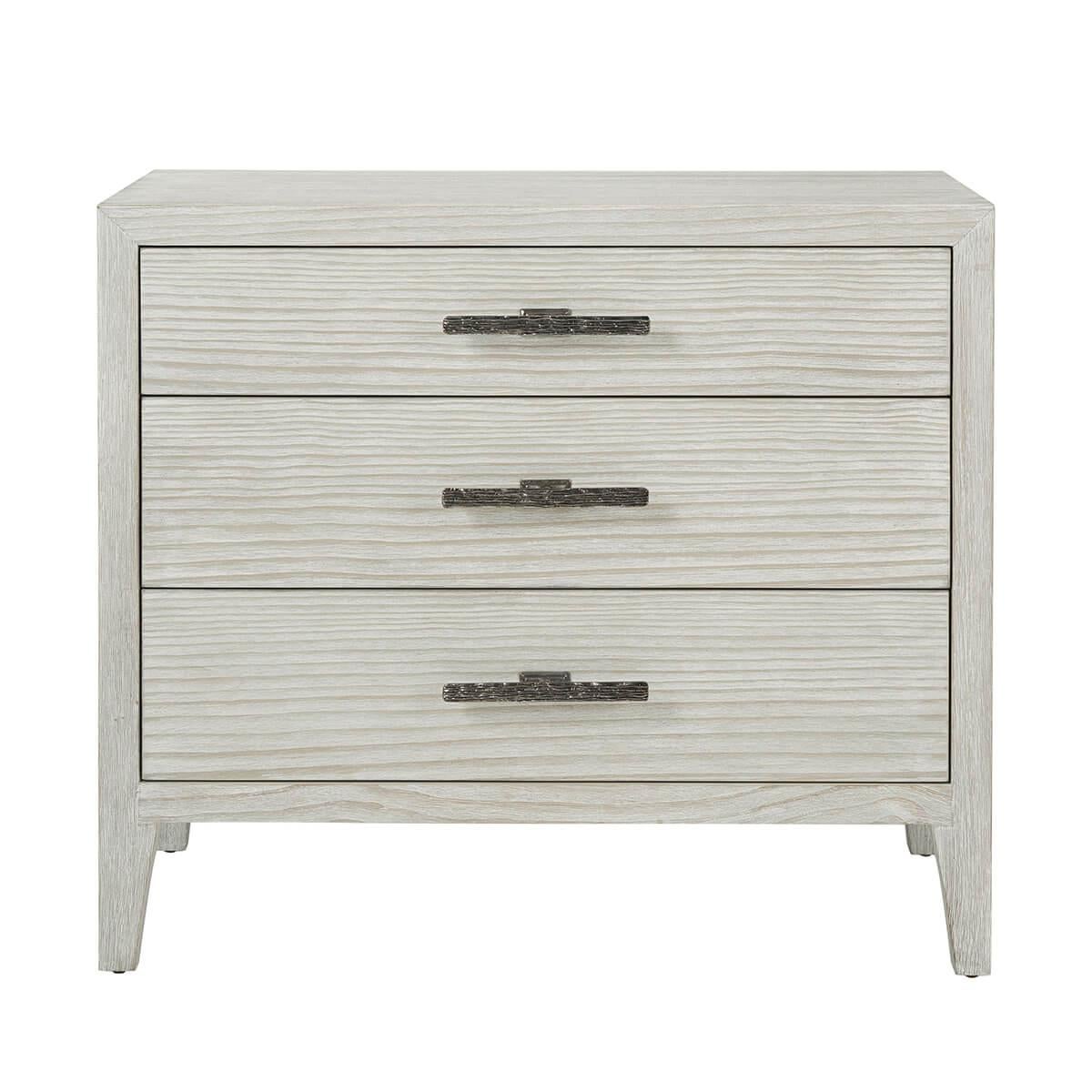In our Sea Salt finish, the nightstand is constructed using quartered pine accented with uniquely cast ribbed bar hardware in the Dark Sterling finish. Resting on tapered legs with three soft closing drawers.

Dimensions: 32