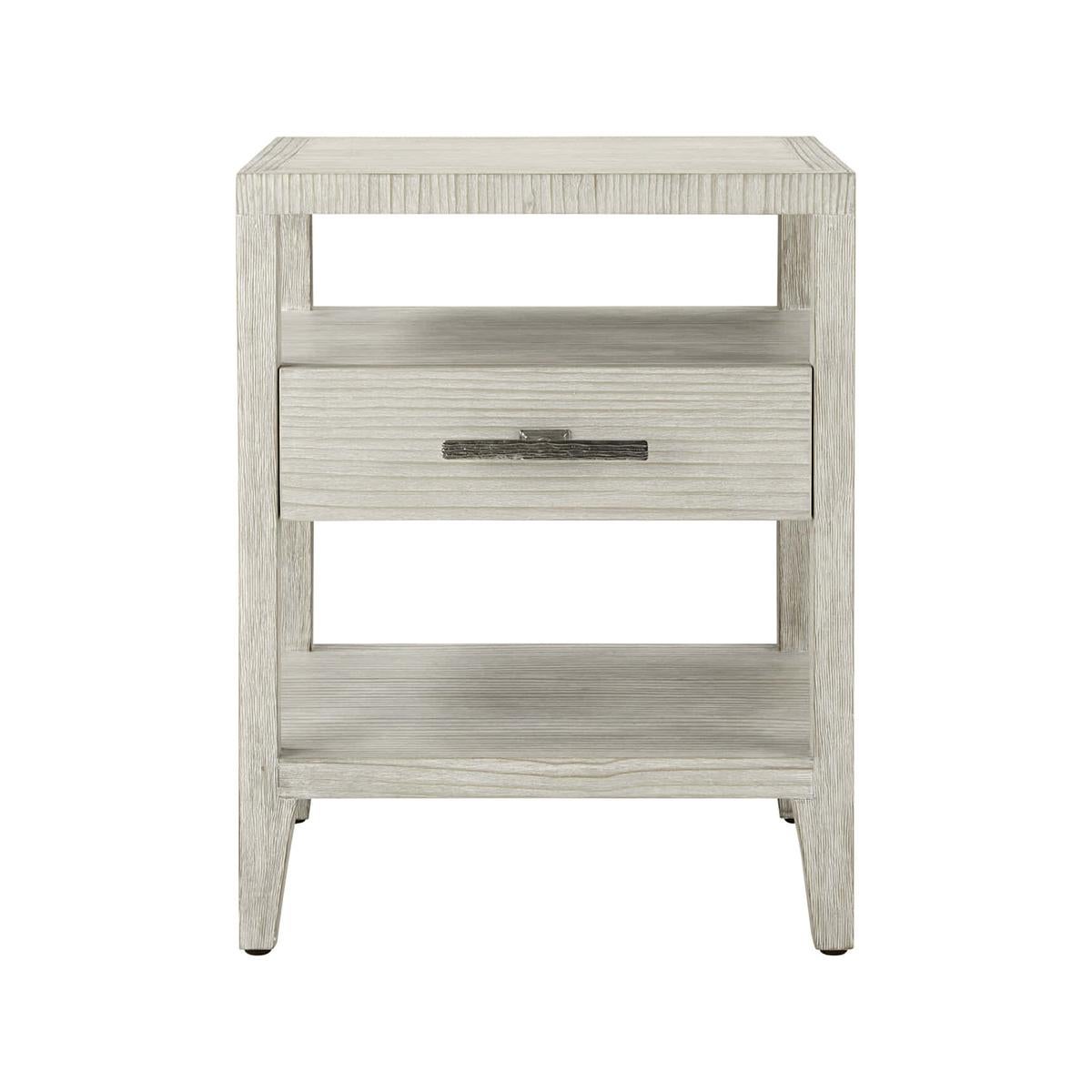Coastal One Drawer Nightstand, composed of wire-brushed cerused pine with the functionality to store and display your favorite decor, this nightstand is the perfect accent piece for any bedroom. Finished with a singular organic ribbed metal bar pull