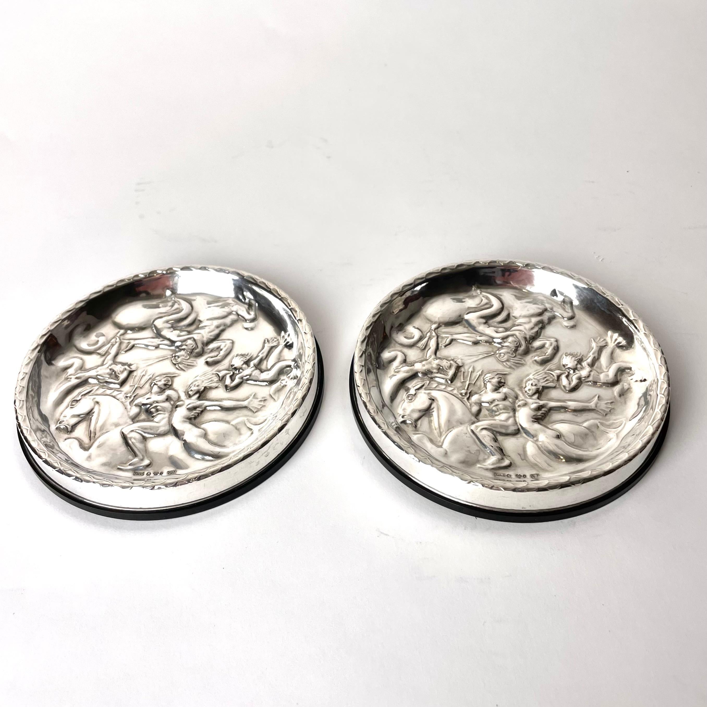 Beautiful pair of Coasters in Silver and Bakelite. After Carl Milles (1875-1955) 
”The wind game” 1937. These coasters are manufactured by GAB 
(Guldsmedsbolaget) in 1964 in Swedish controlled silver.


Wear consistent with age and use 