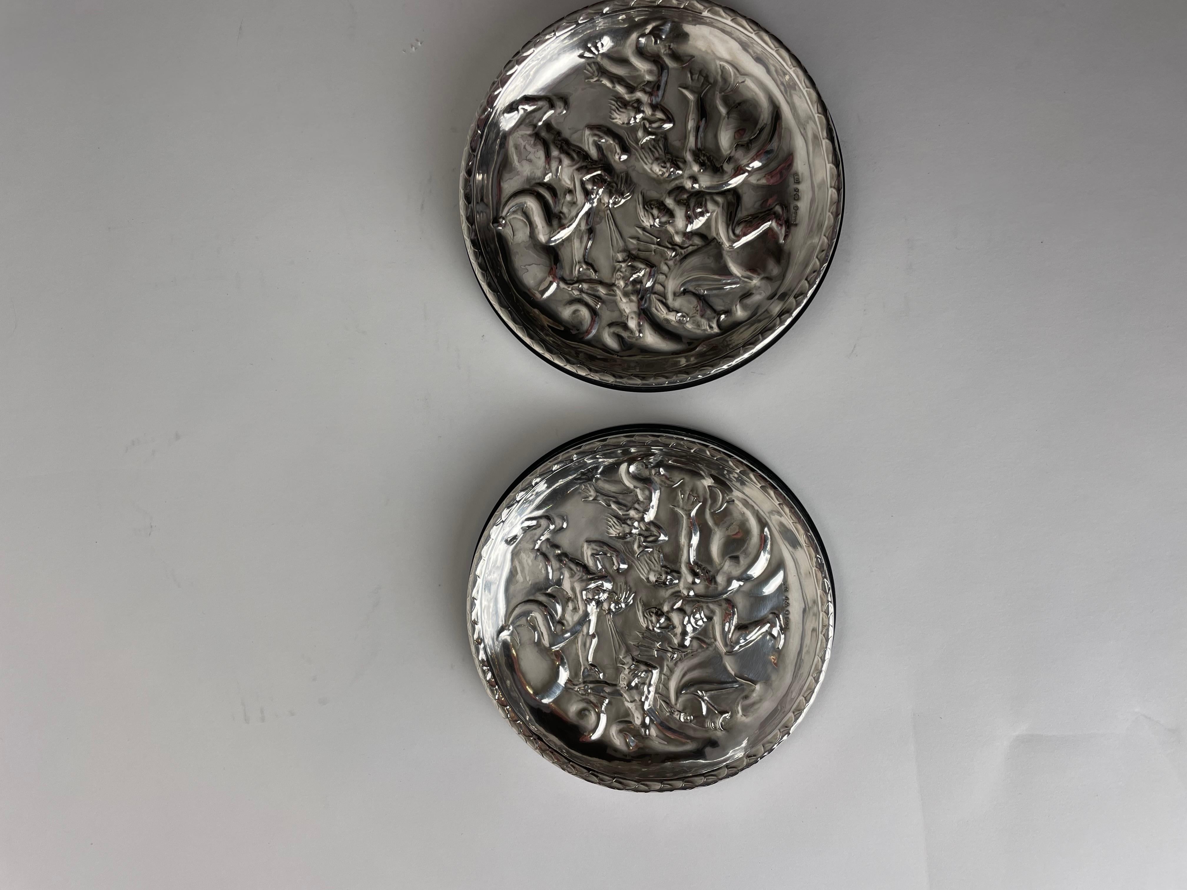 Swedish Pair of Coasters in Silver and Bakelite. After Carl Milles ”The wind game” 1937 For Sale