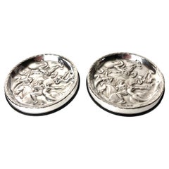Used Pair of Coasters in Silver and Bakelite. After Carl Milles ”The wind game” 1937