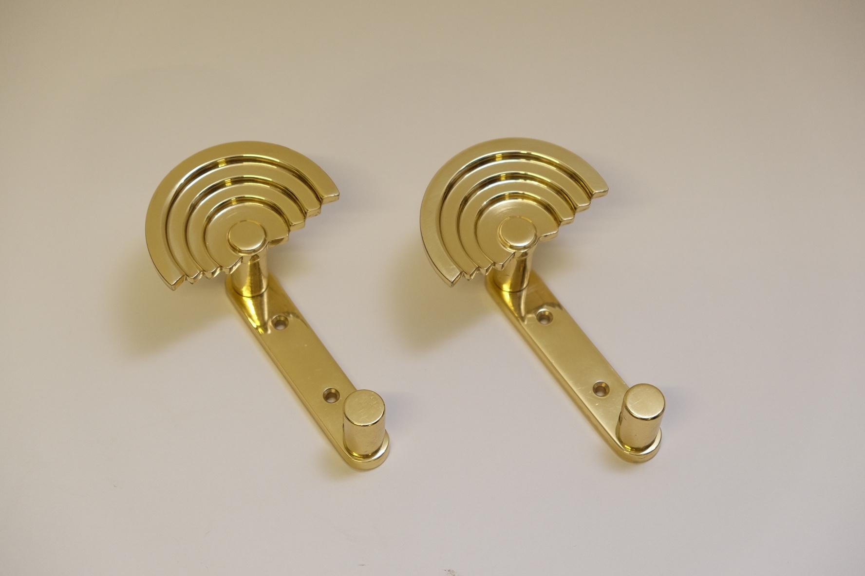 A pair of coat hooks designed by Ettore Sottsass in 1985 for Valli & Valli.
Crafted from solid brass, the coat hooks are shaped like an umbrella or rainbow.
Good original condition with signs of wear where the coat hooks are hung.
Easy to attach