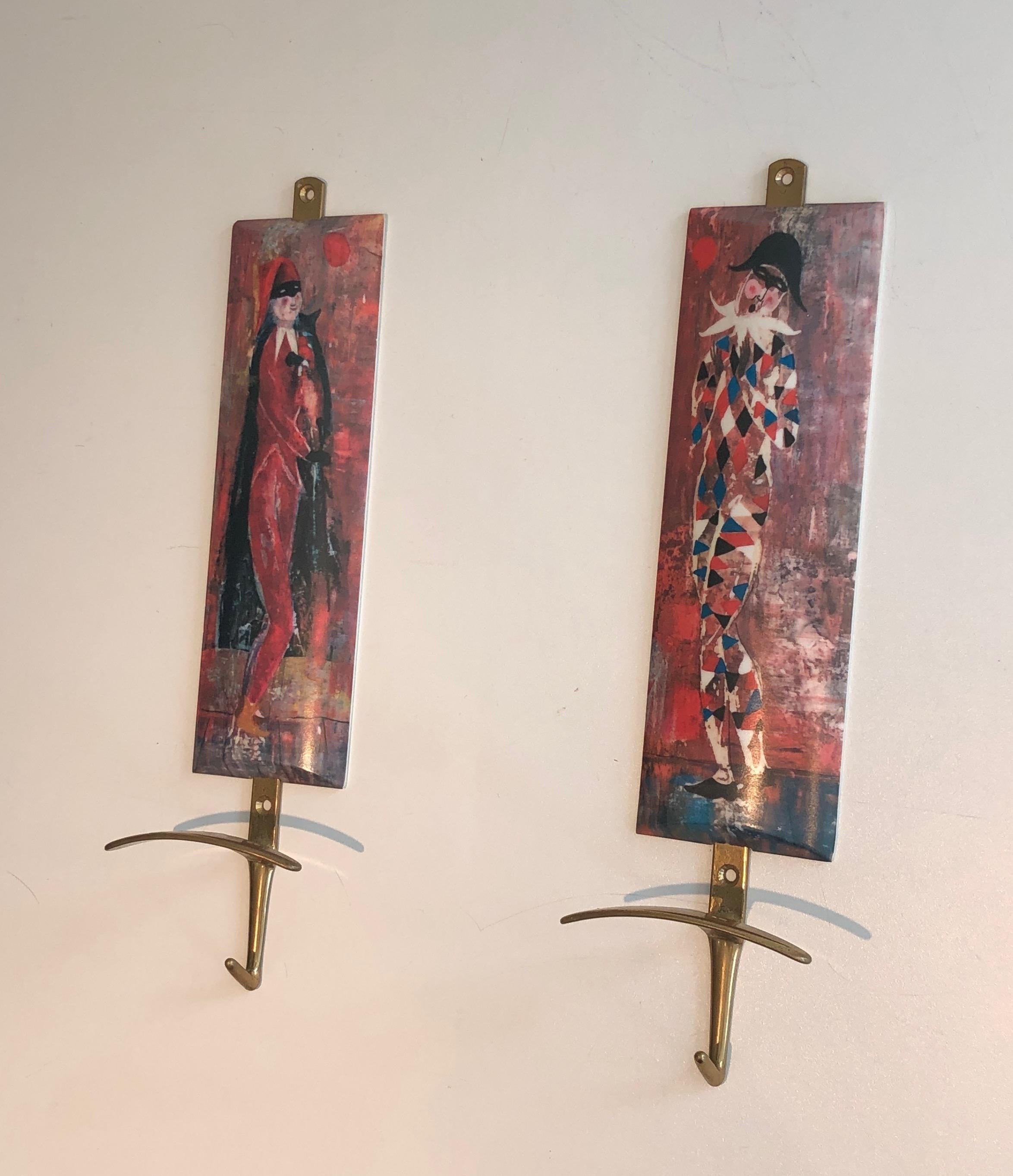 This pair of hooks representing characters from Comedia Del Arte is made of plastic and brass. This is an Italian work in the style of Piero Fornasseti. Circa 1970