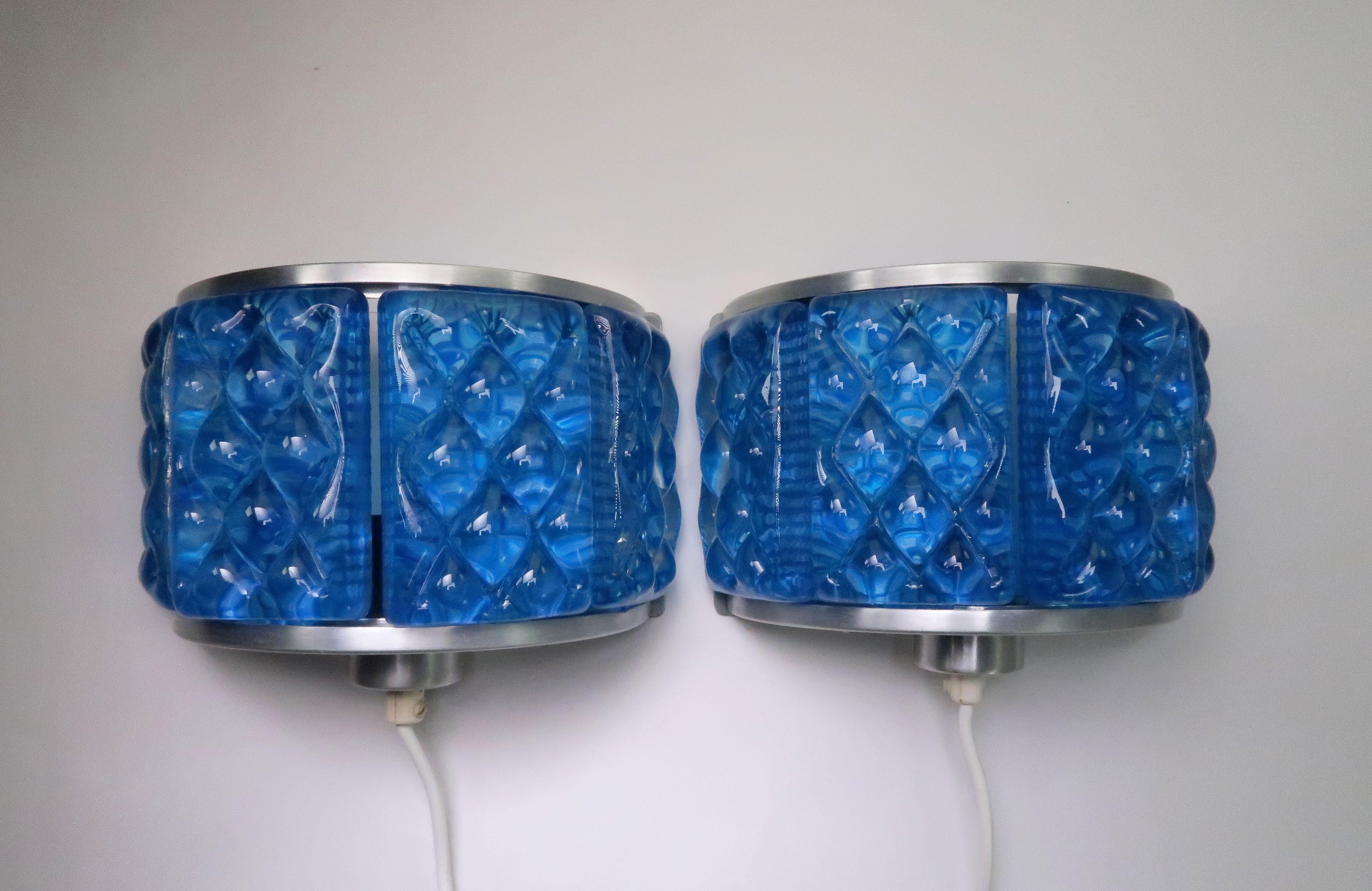 Beautiful set of Danish Mid-Century Modern pressed, clear blue glass wall lights by Vitrika in collaboration with Swedish Orrefors. Half-spherical shaped wall sconces featuring four thick, textured, cobalt blue glass pieces secured and held in place