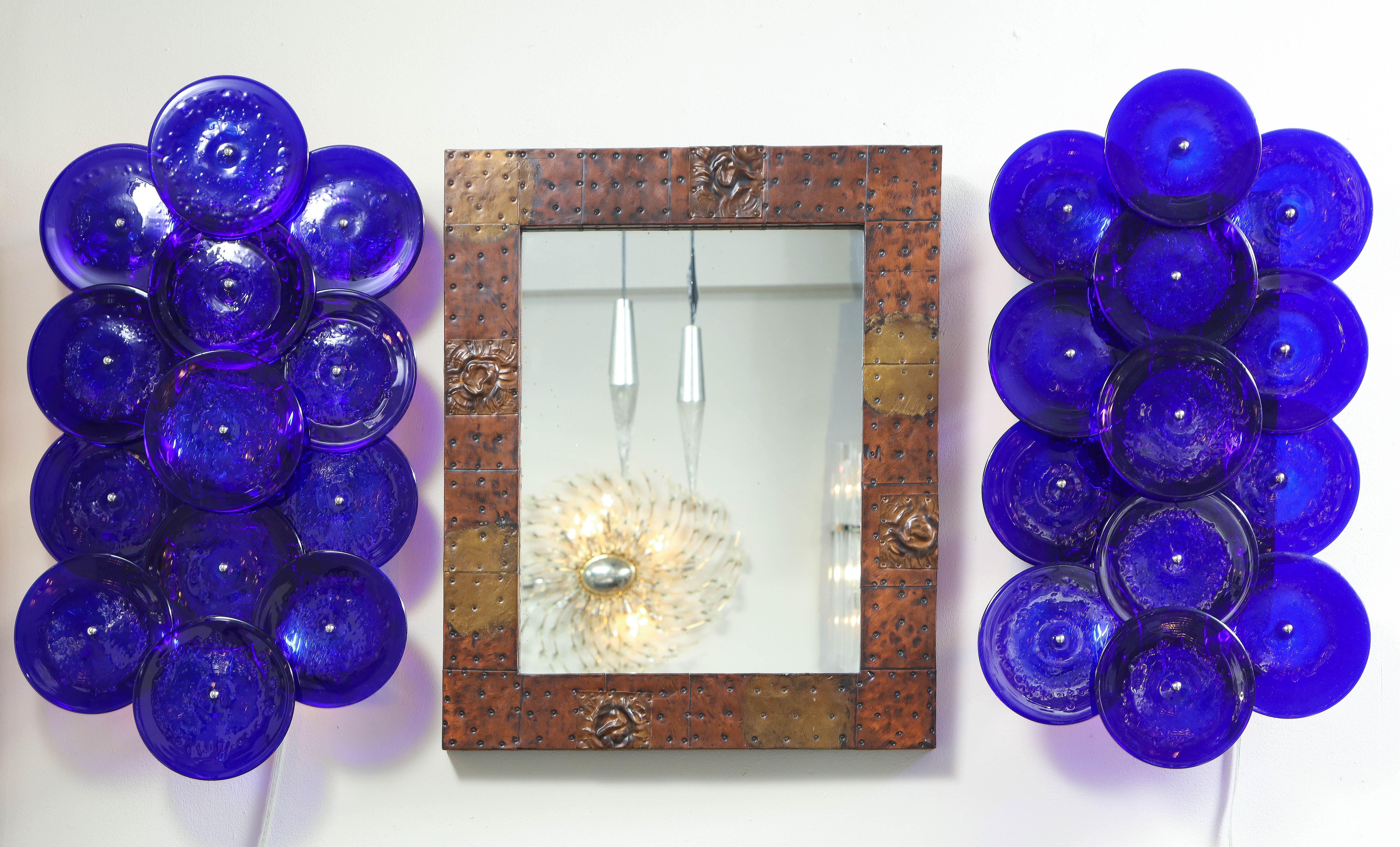 One of a kind pair of sconces seen in images available for immediate purchase. The pair is in pristine condition and has cobalt blue glass discs which were made in custom color. Custom order is also available in different glass colors, finishes, and