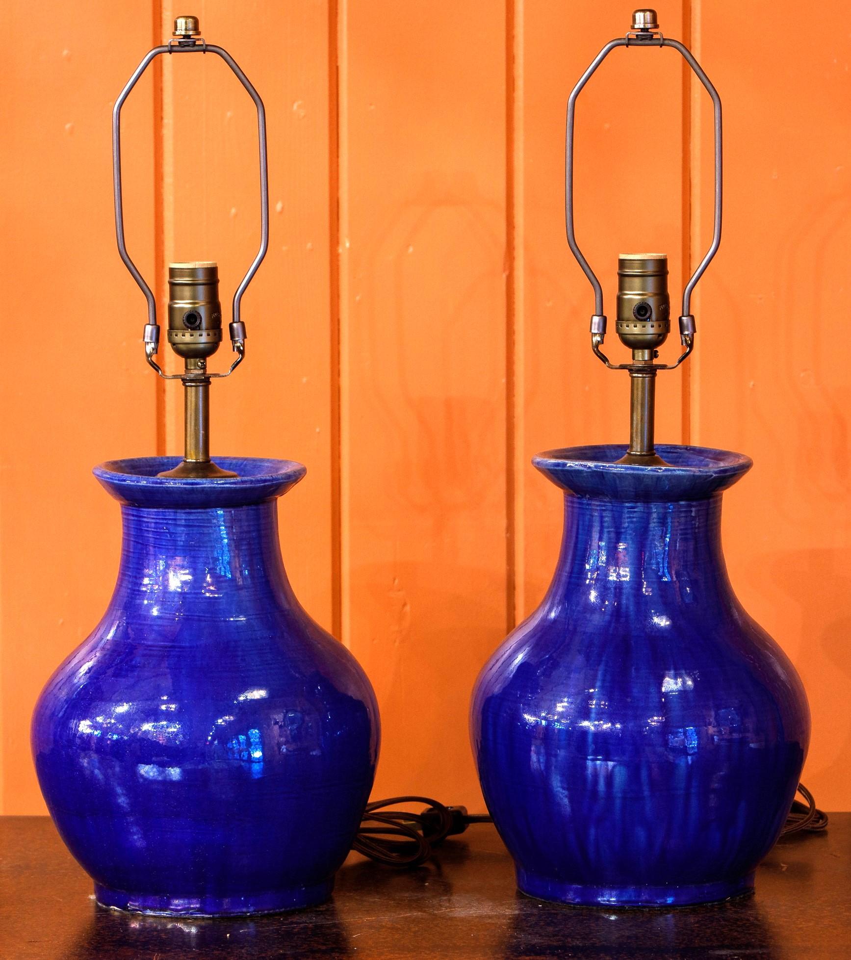 Pair of hand-thrown, hand-painted, cobalt glazed stoneware lamp. Newly wired with all UL listed parts. Versatile, minimalist style that would complement almost any style. Measurement is to the top of socket. 