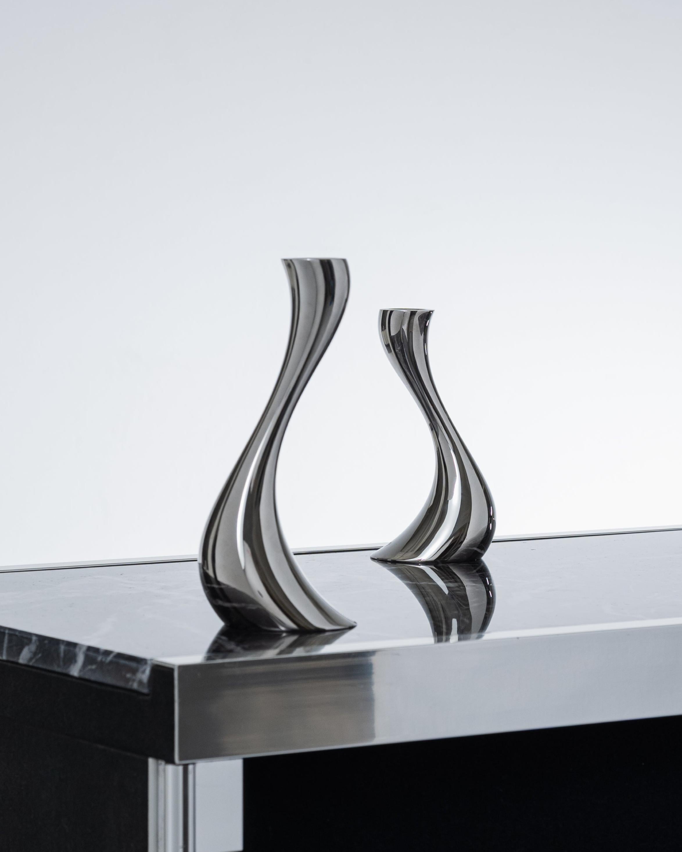 Pair of candleholders from the Cobra collection, produced by Georg Jensen in the 2000s. Made of polished metal, featuring the organic and flowing design typical of contemporary Scandinavian style. Signed on the base. Very good condition.

DV4625-4626