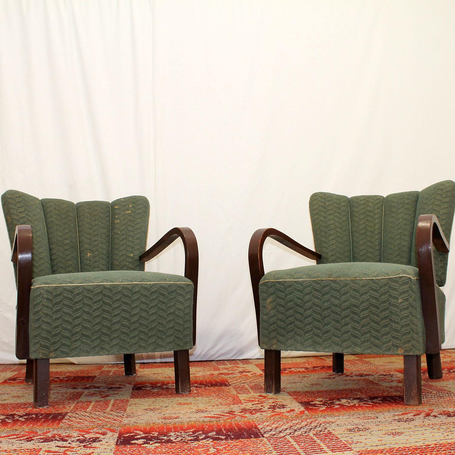 These “cocktail” armchairs Catalog No. H-237 were designed by Jindrich Halabala. Made in te former Czechoslovakia in the 1950´s. Very interestingly shaped chair. It features a dark stained beech wood structure and original upholstery. The chairs are