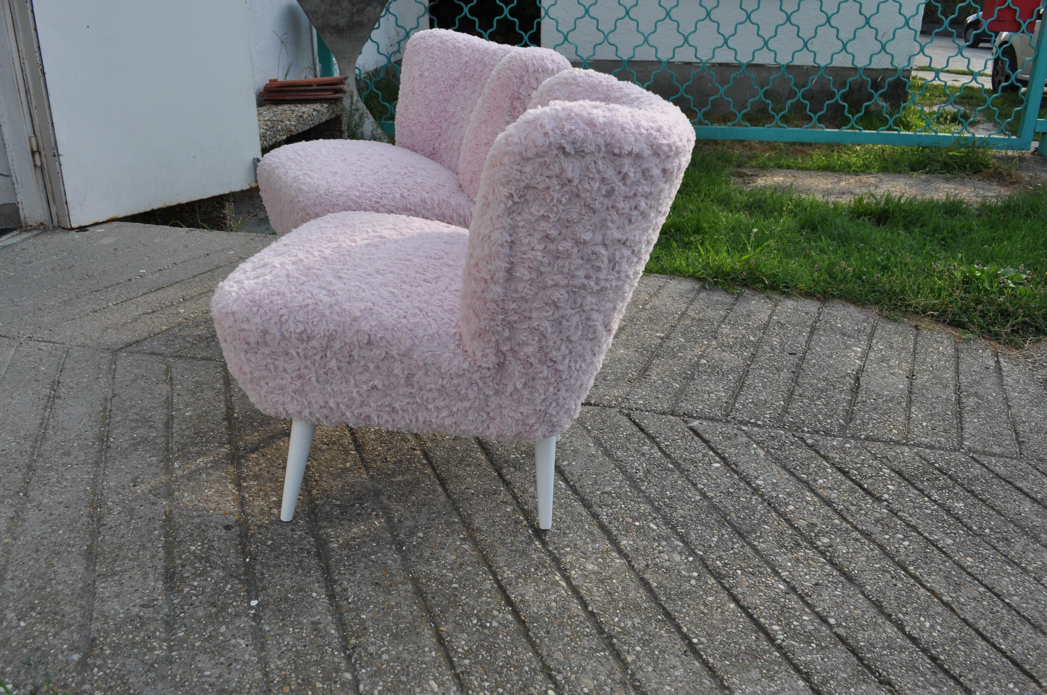 1950s shell back cocktail chairs recovered with a light pink faux fur. Very well constructed, extremely comfortable.
The pair was fully re-upholstered with a pink colored faux fur.