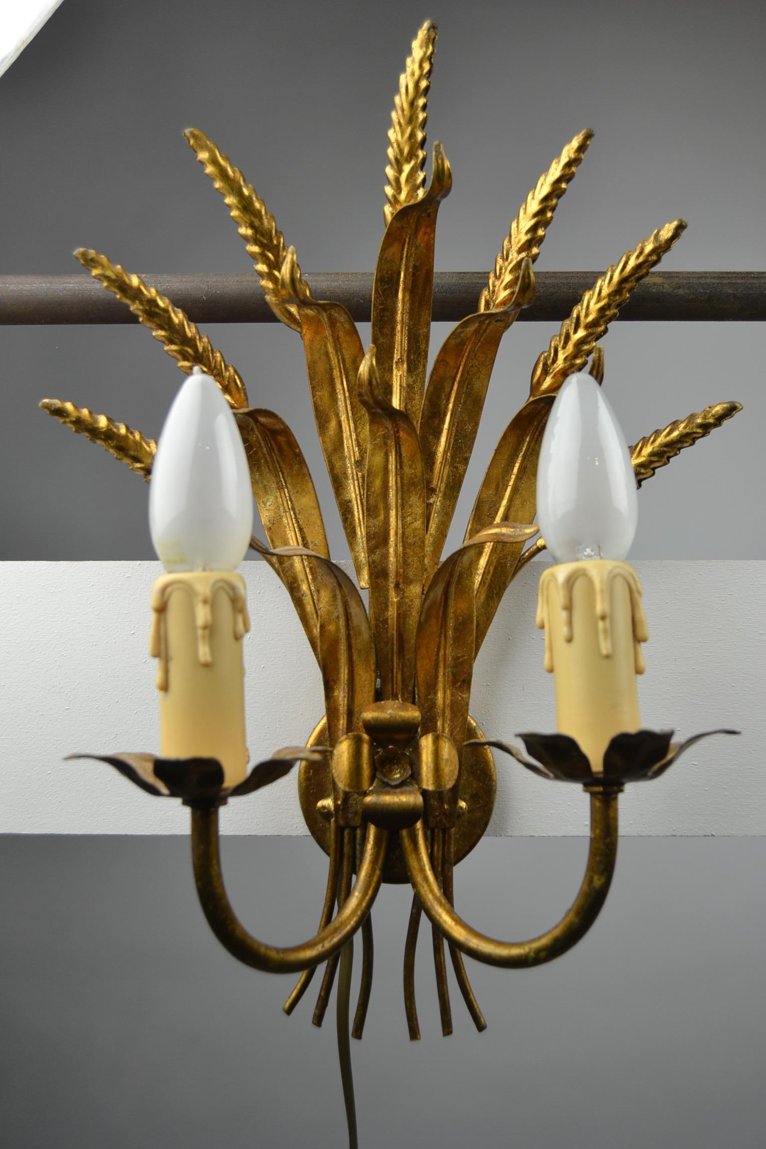 Stylish Pair of Coco Chanel Style Wall Lights with Gold Florentine Finish. 
These Hollywood Regency Style Wall Scones with Gilt Sheaf of Wheat have each two arms with  two lights. A great pair of 1970s lighting. 
 