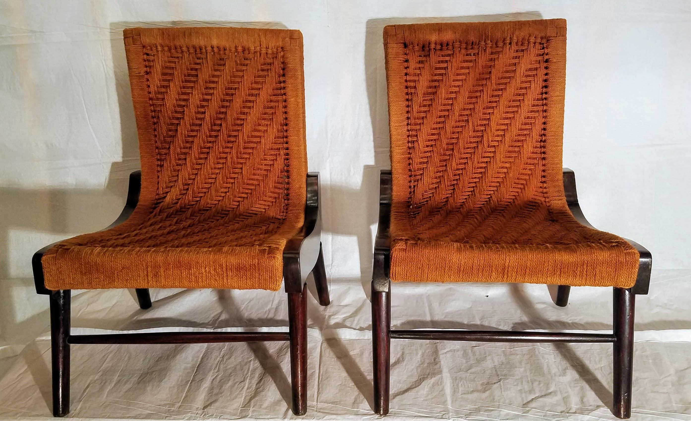 Pair of rare cocobolo rosewood South American lounge chairs wrapped in hemp cord in a herringbone pattern.
The chairs were brought back to Virginia by an OSS officer stationed in Central America during World War II.
The seats have been rewrapped