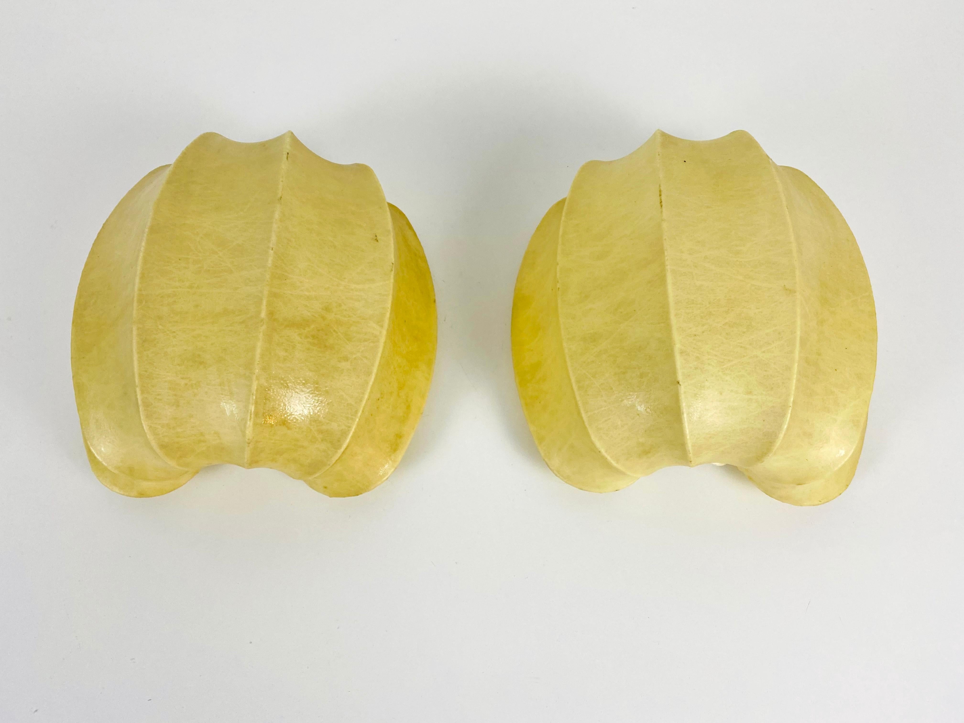 Pair of rare cocoon wall lamps made in Germany in the 1960s. The lamp shade is made of cocoon and has a beautiful shape. 

The light requires one E27 (US E26) light bulb. Works with both 120/220V. Good vintage condition.

Free worldwide express