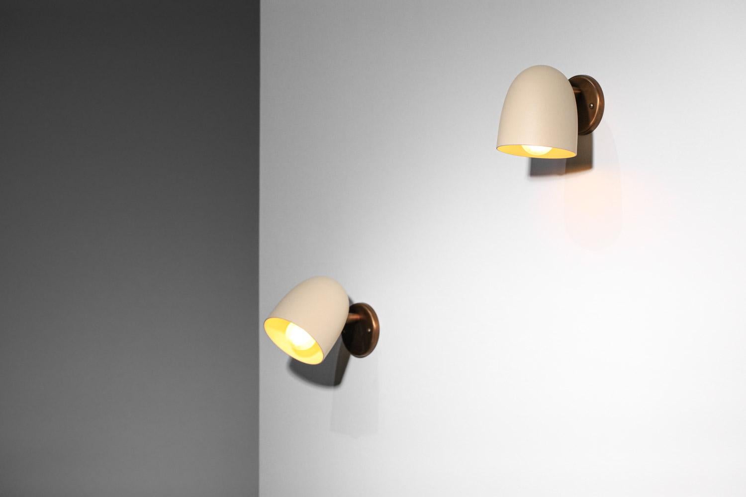 Contemporary pair of Danke Studio sconces brass and lacquered metal 