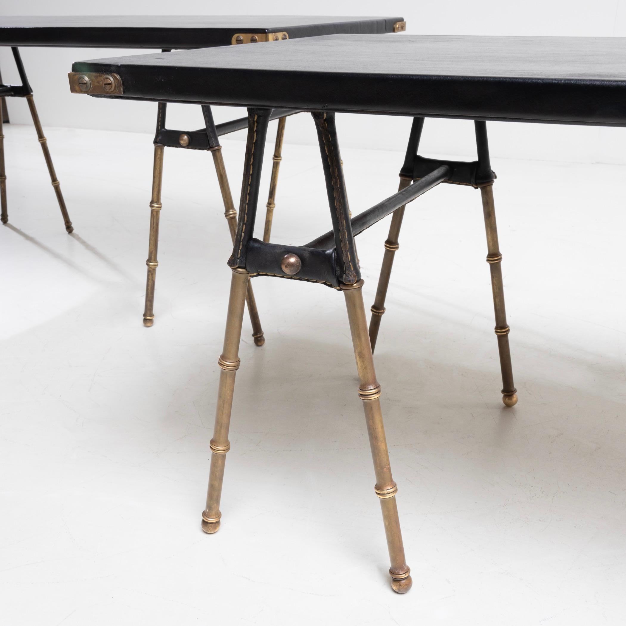 20th Century Pair of coffee tables with trestle legs by Jacques Adnet For Sale