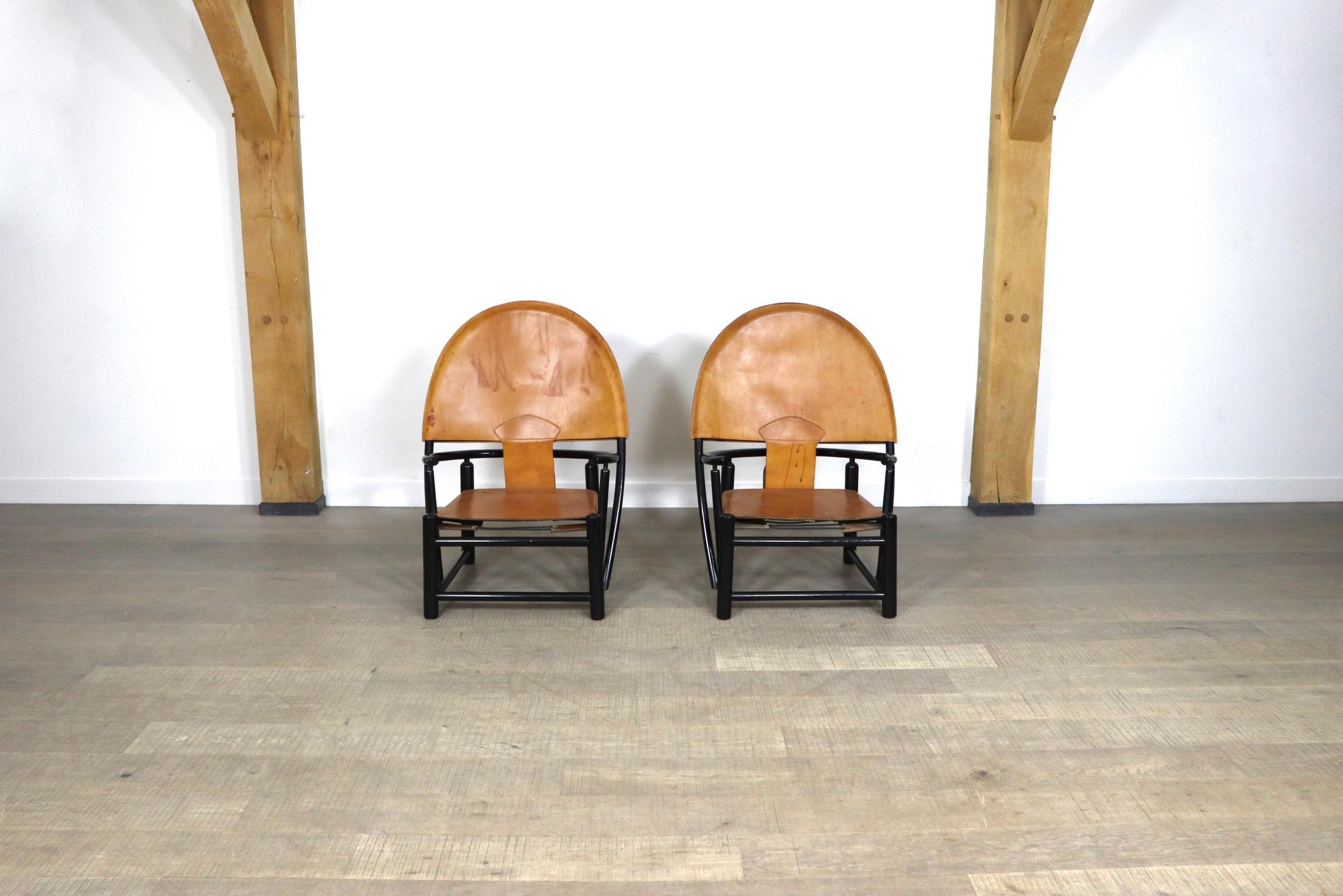 alange & Werther Toffoloni in beautifully patinated cognac leather and black lacquered wooden frame. This beautiful chairs were produced by Germa in 1972 and became known as the 'Hoop' chair.
This high quality chairs, with steam bent beech frame,