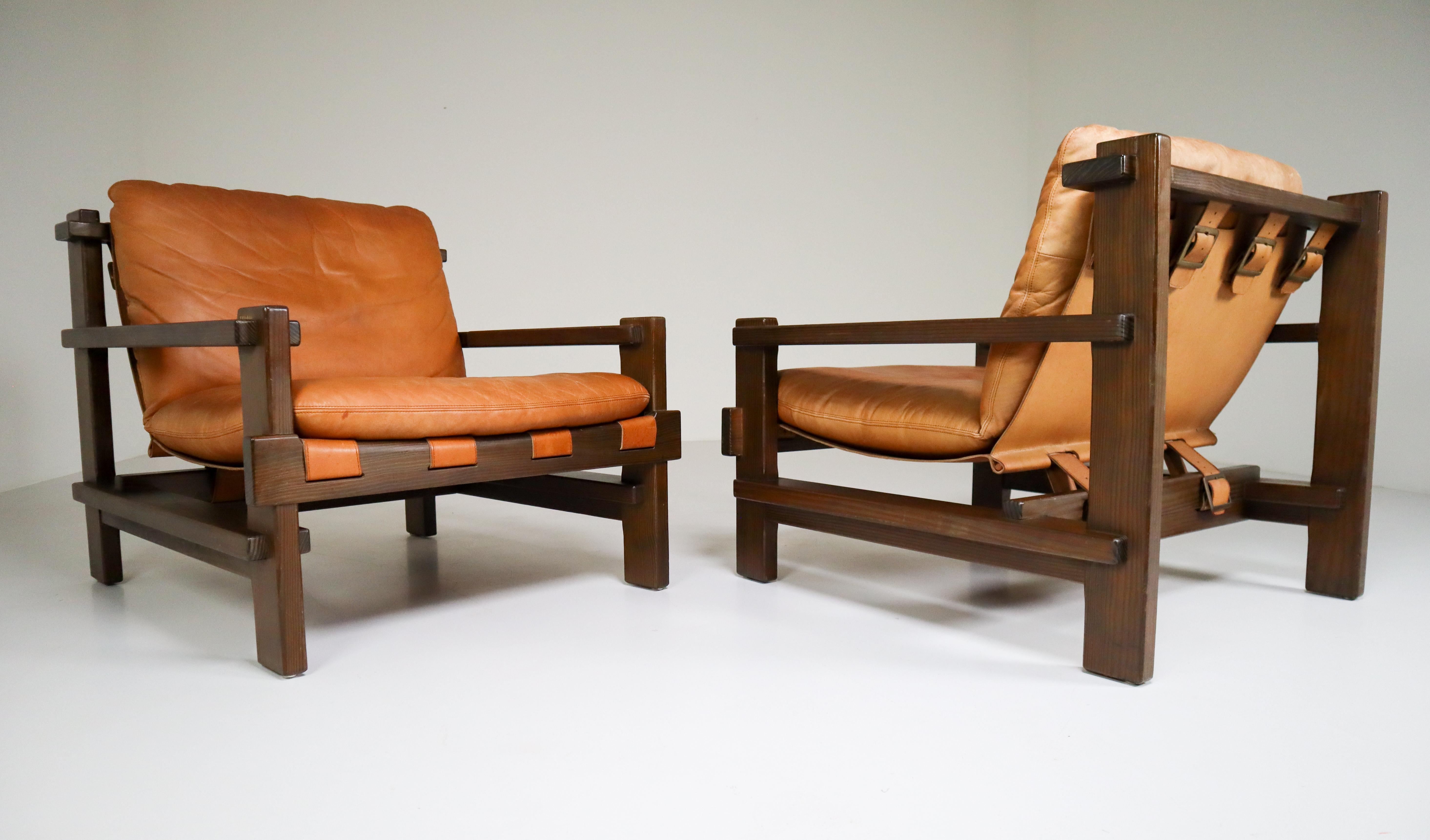 Pair of lounge chairs by Carl Straub in absolutely gorgeous cognac leather and solid pinewood, circa 1960s. The the soft leather is beautifully patinated during use and age and. Altogether a lovely set that not only attracts attention by its well