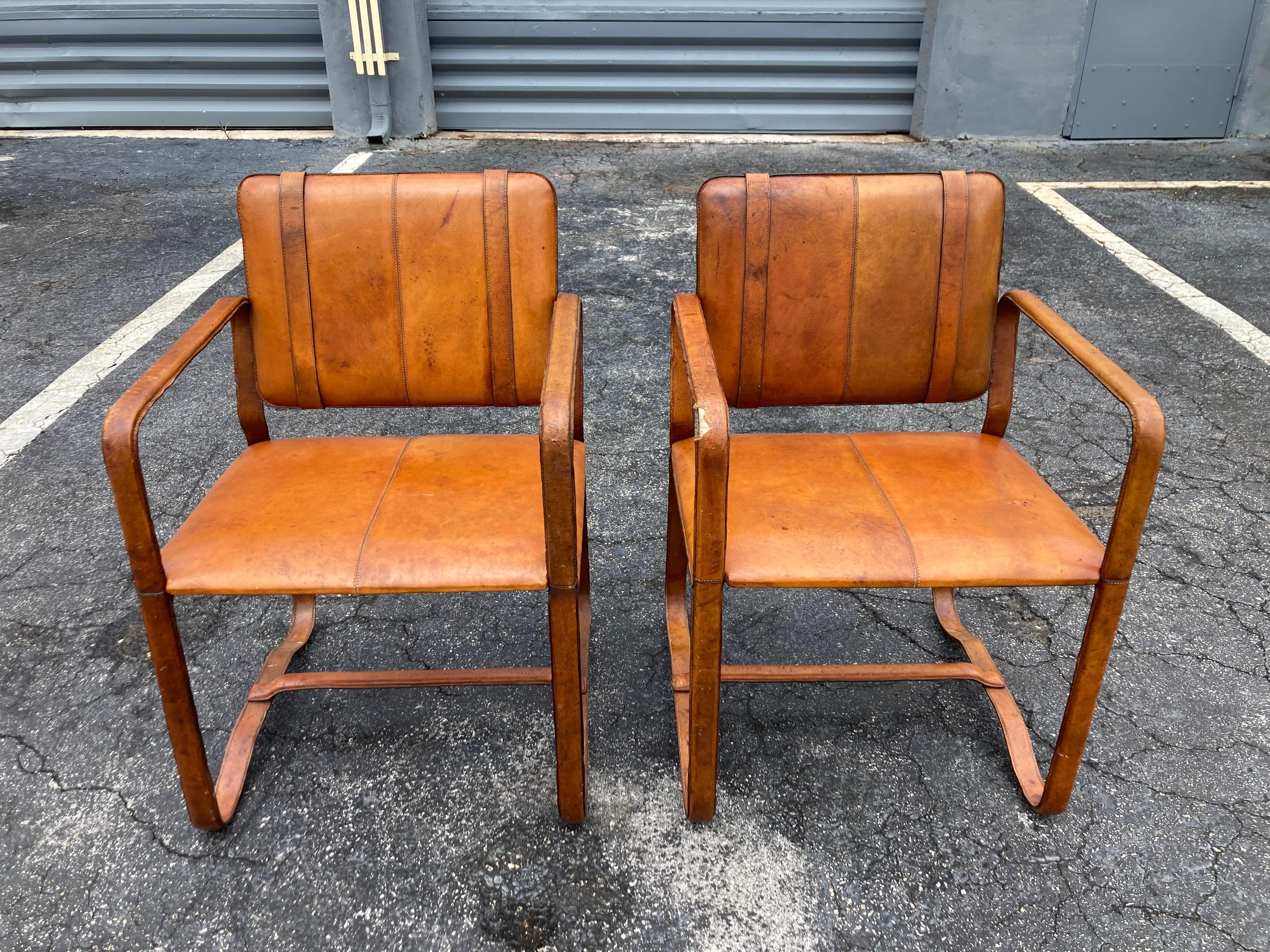 Pair of Cognac Leather Wrapped Arm Chairs in the style of Jacques Adnet In Good Condition In Miami, FL