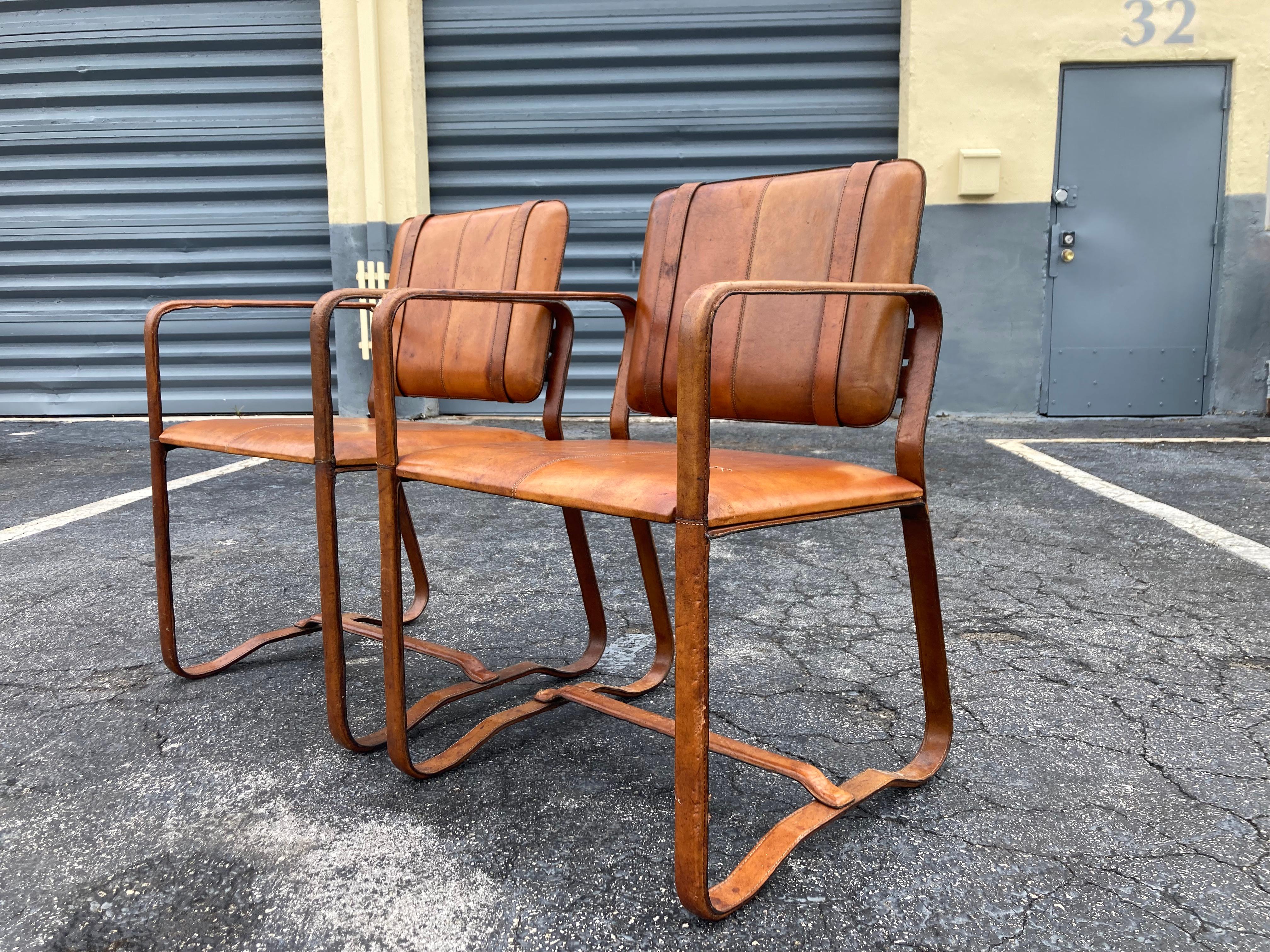 Late 20th Century Pair of Cognac Leather Wrapped Arm Chairs in the style of Jacques Adnet