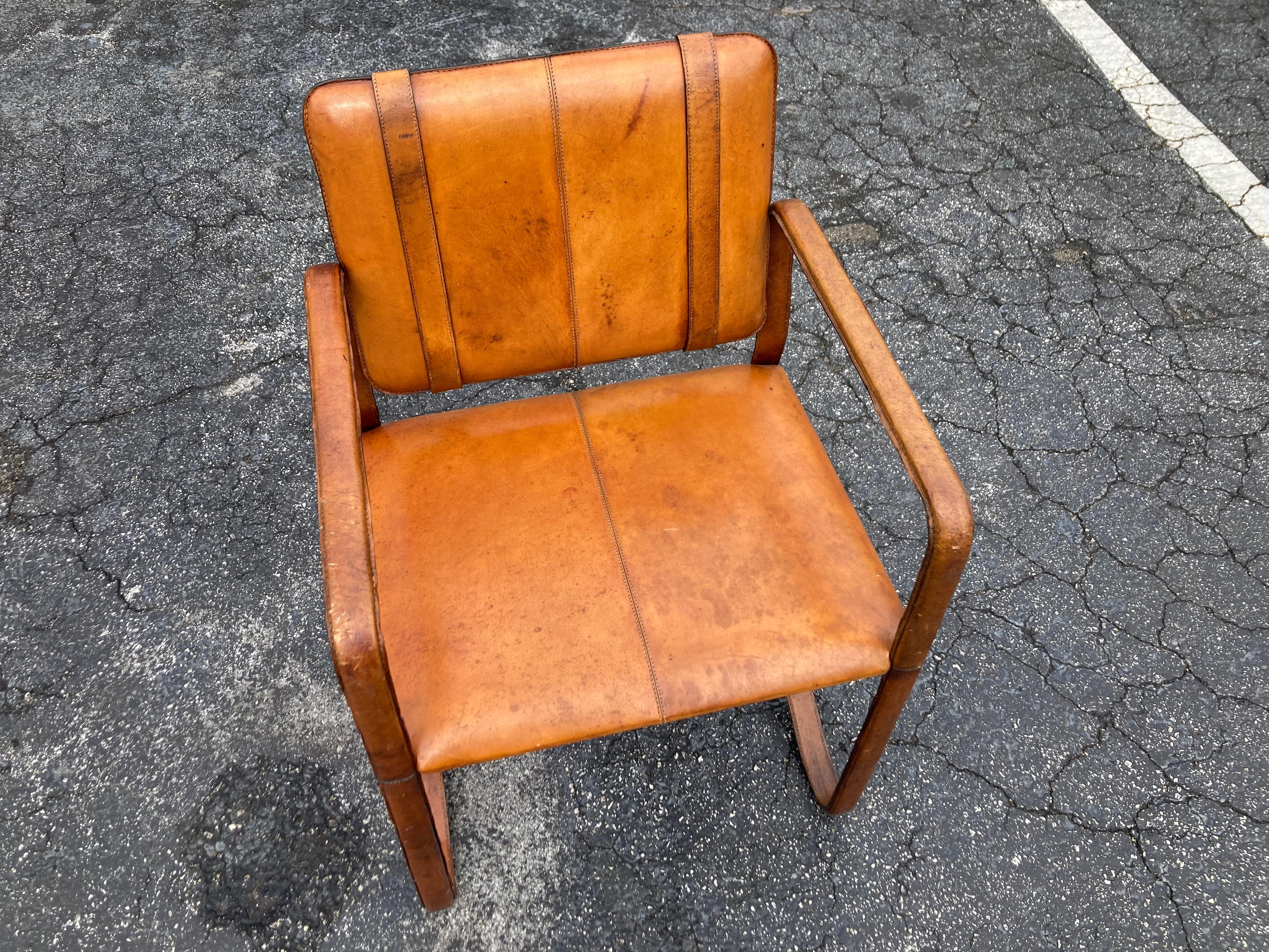 Pair of Cognac Leather Wrapped Arm Chairs in the style of Jacques Adnet 1
