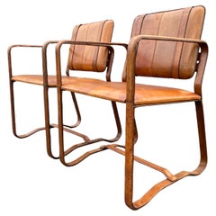 Pair of Cognac Leather Wrapped Arm Chairs in the style of Jacques Adnet