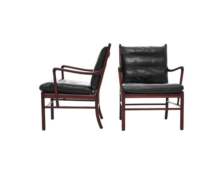 Pair of 'Colonial' armchairs in mahogany, cane and original leather. Elegant pair easy chairs with a mahogany slim frame by the Danish designer Ole Wanscher. These chairs show the great craftsmanship and attention to detail that Ole Wanscher is