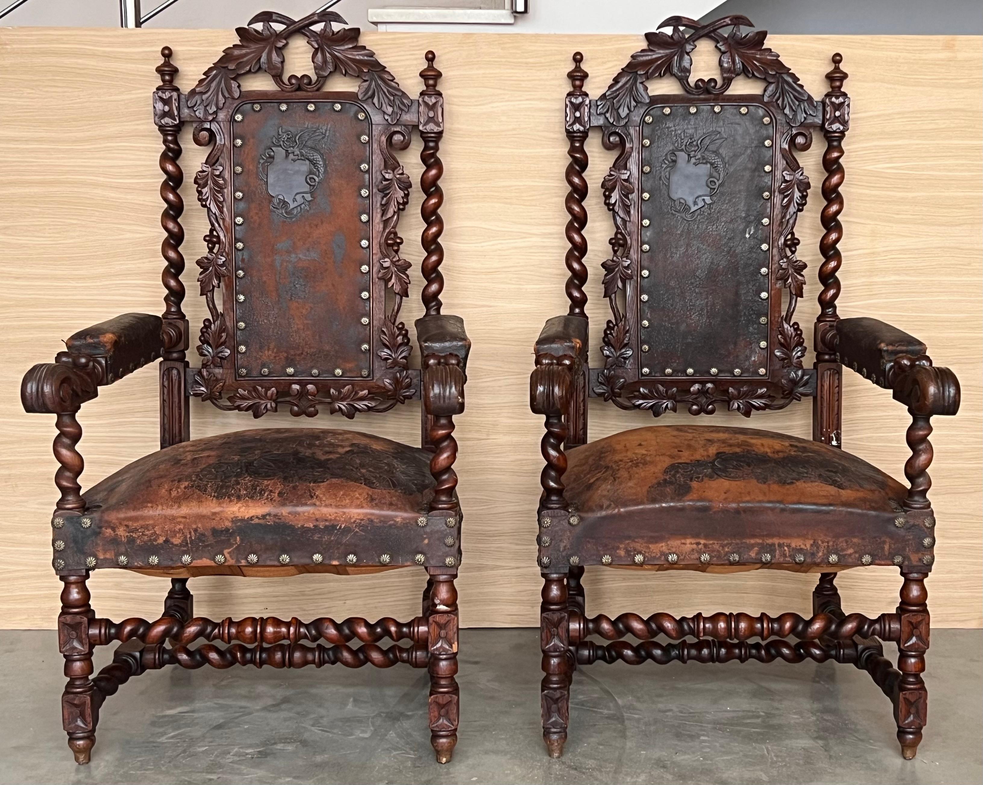 Pair of Spanish Colonial style armchairs, having carving leather seats and backs, brass nailheads and a beautiful patina throughout, turned legs and carved top,
18th century or earlier.

Measures: Height to the arm 28.34 in.
