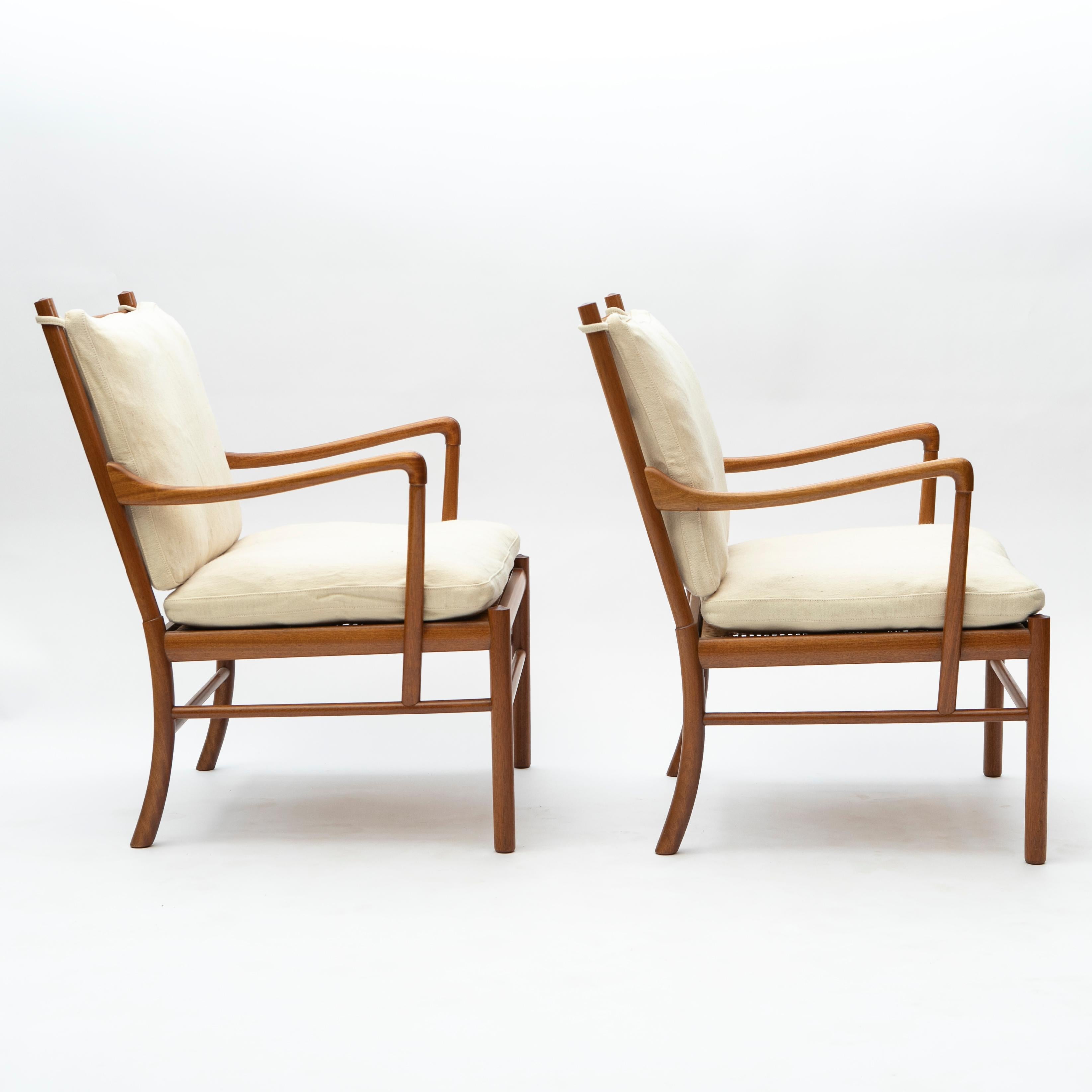 Ole Wanscher (Danish, 1903-1985).

Pair of Colonial Chairs designed by Ole Wanscher.
Crafted in solid mahogany with woven rattan cane seat and original cushions covered in light Greenland wool.

Produced by Poul Jeppesen in Denmark circa