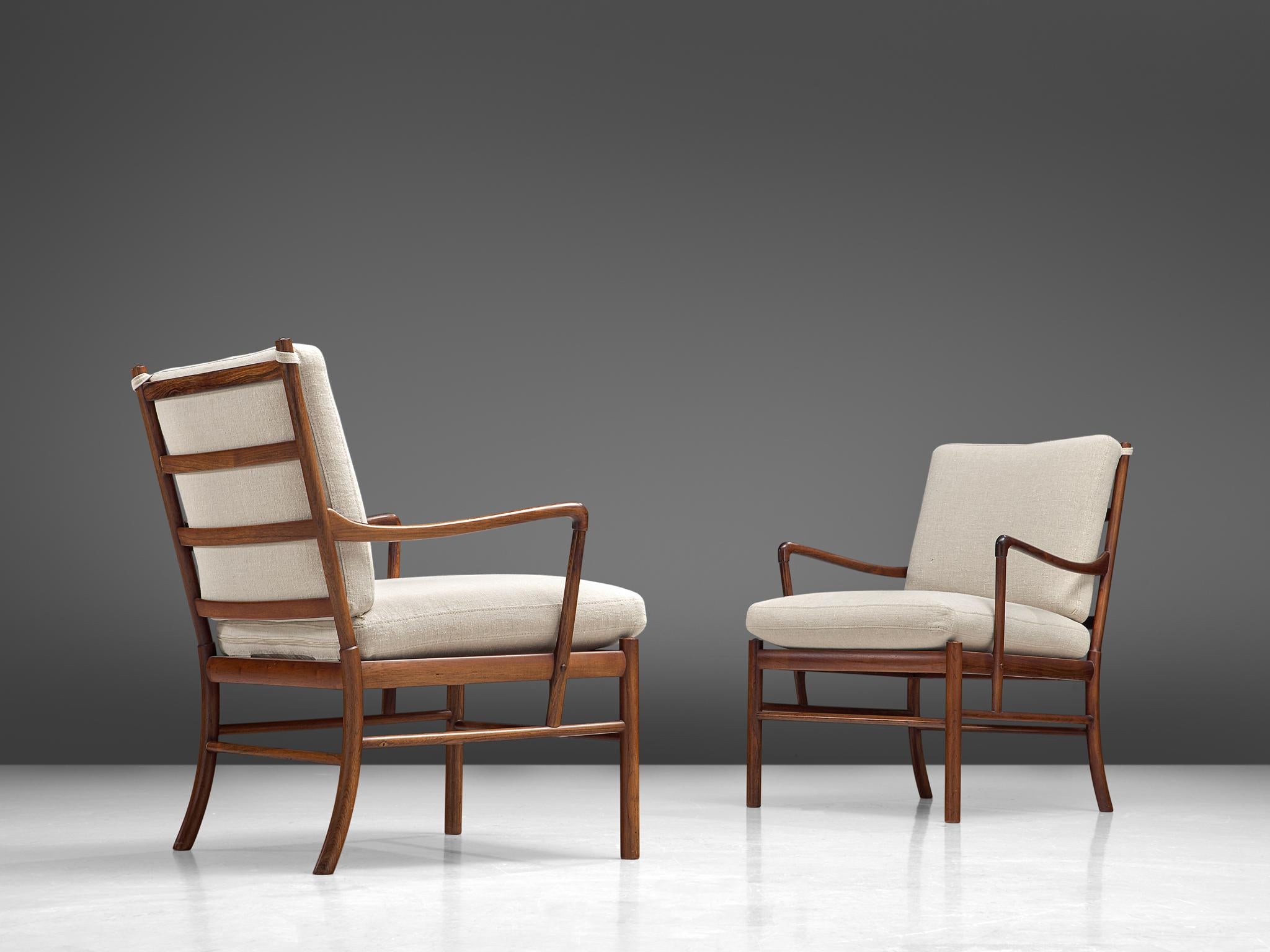 Ole Wanscher for Poul Jeppesen, pair of 'Colonial' armchairs, rosewood, cane and fabric, Denmark, 1949

Elegant pair easy chairs that are executed a slim frame of rosewood, designed by the Dane Ole Wanscher. The lounge chairs feature the great