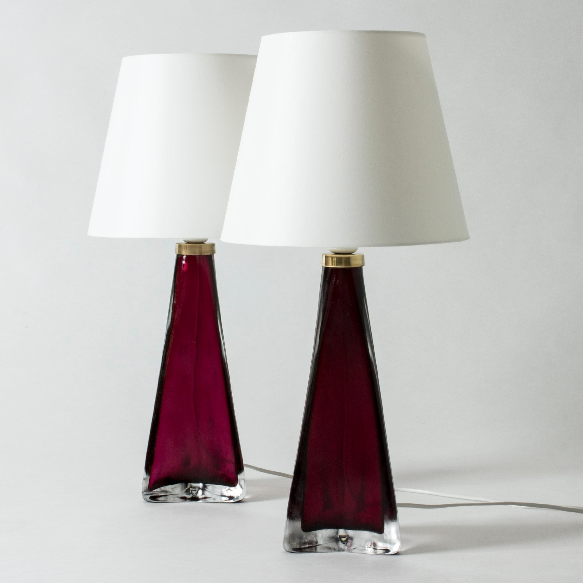 Pair of cool and luxurious table lamps by Carl Fagerlund, made in beautiful dark pink and clear glass. Tapering shape with a triangular base. Slightly frosted surface with structure. Rare color.
