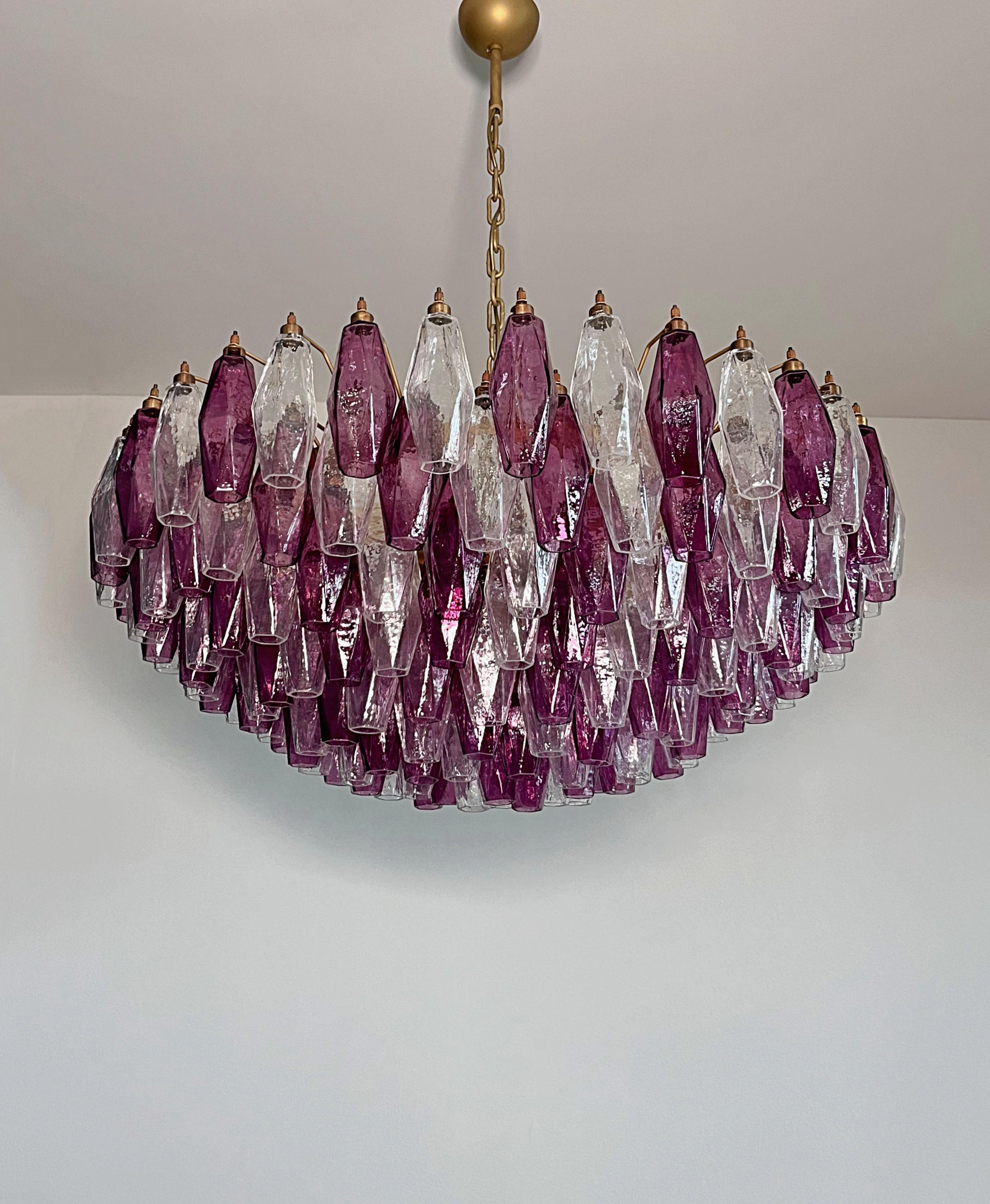Pair of Huge Colorful Eclectic Murano Chandeliers in the style of Carlo Scarpa with beautiful hand blown poliedri prisms in a bold fuchsia color as well as clear glass.
Lamp structure painted in a golden bronze tone. You can choose to have the lamp