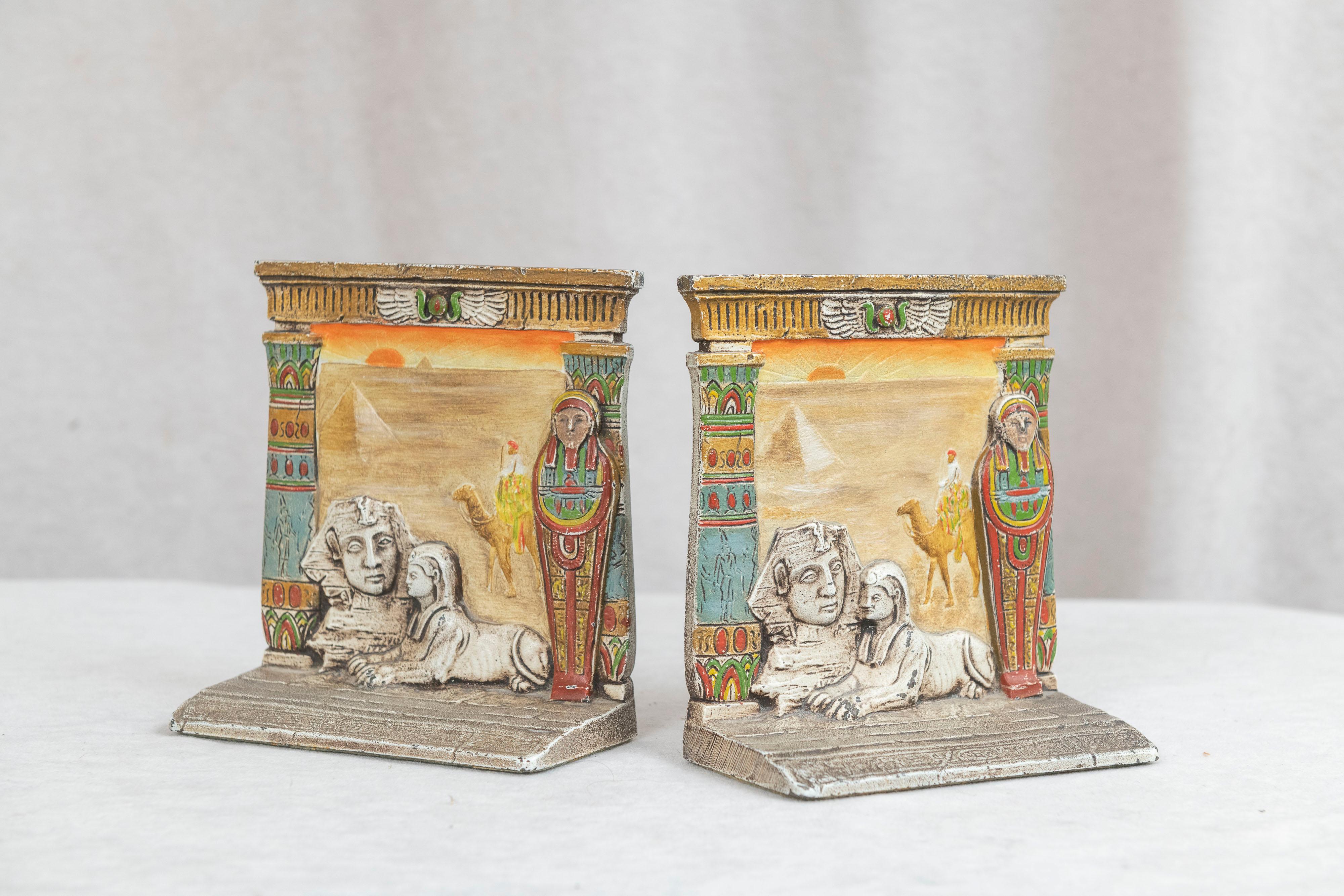 These highly detailed colorful bookends were done by the best creator of bookends, the Judd Co. With the Egyptian theme and done in bas relief you get a wonderful story told. Sphinx, Sarcophagus, Camel, Scarab, it's all there. Made from cast iron