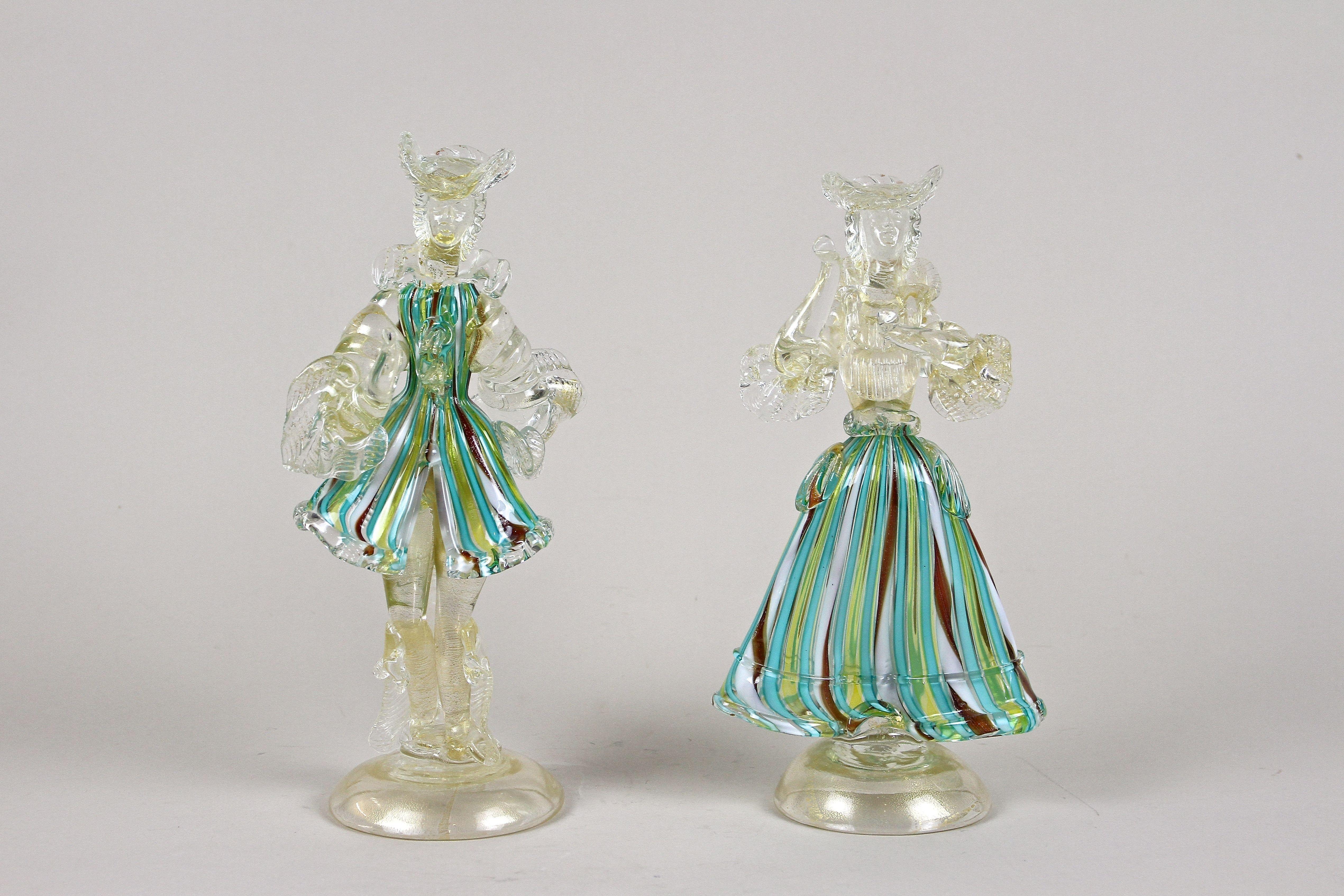 Exceptional pair of fine Murano Glass Figurines from the small island of Murano around 1950. The outstanding crafted figurines show the incredible skills of the famous glass artists at its best. Depicting a couple in a beautiful Venetian festive