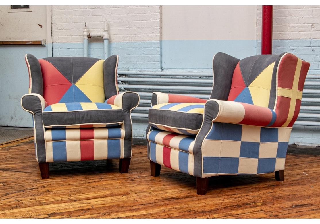 Comfortable wing style club chairs upholstered in nautical colored canvas type pieced fabric. The seats striped, the sides in a checkerboard pattern.
Measures: Height 33