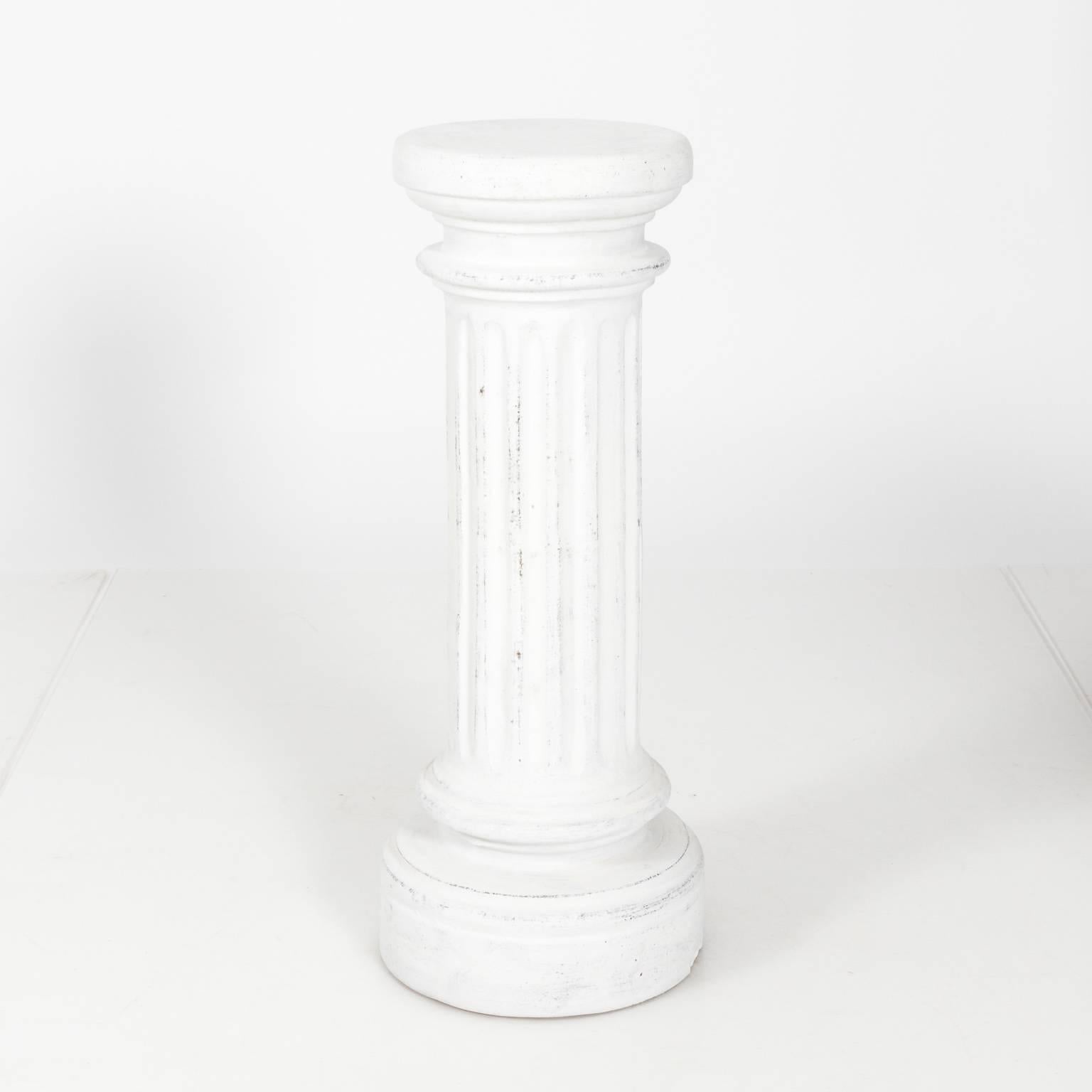 Pair of fluted column pedestals in a white painted finish, circa 20th century.